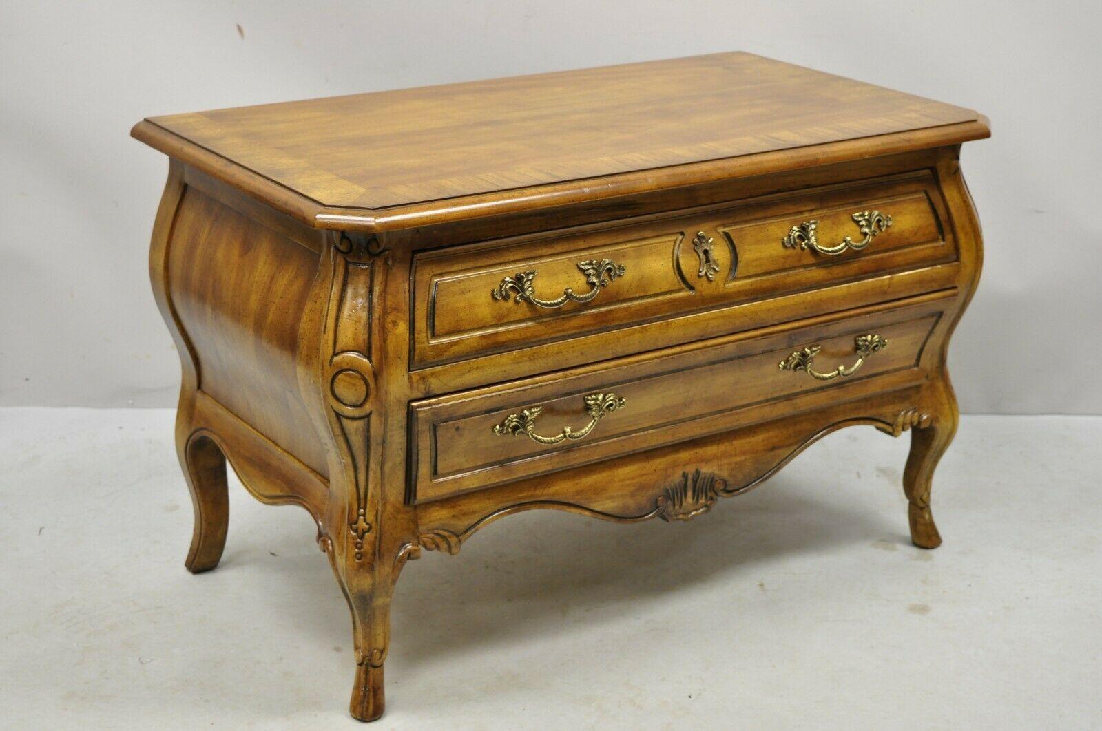 Drexel Heritage French Provincial fruitwood bombe low commode nightstand. Item features a banded top, solid wood construction, beautiful wood grain, nicely carved details, 2 dovetailed drawers, solid brass hardware, quality American craftsmanship,