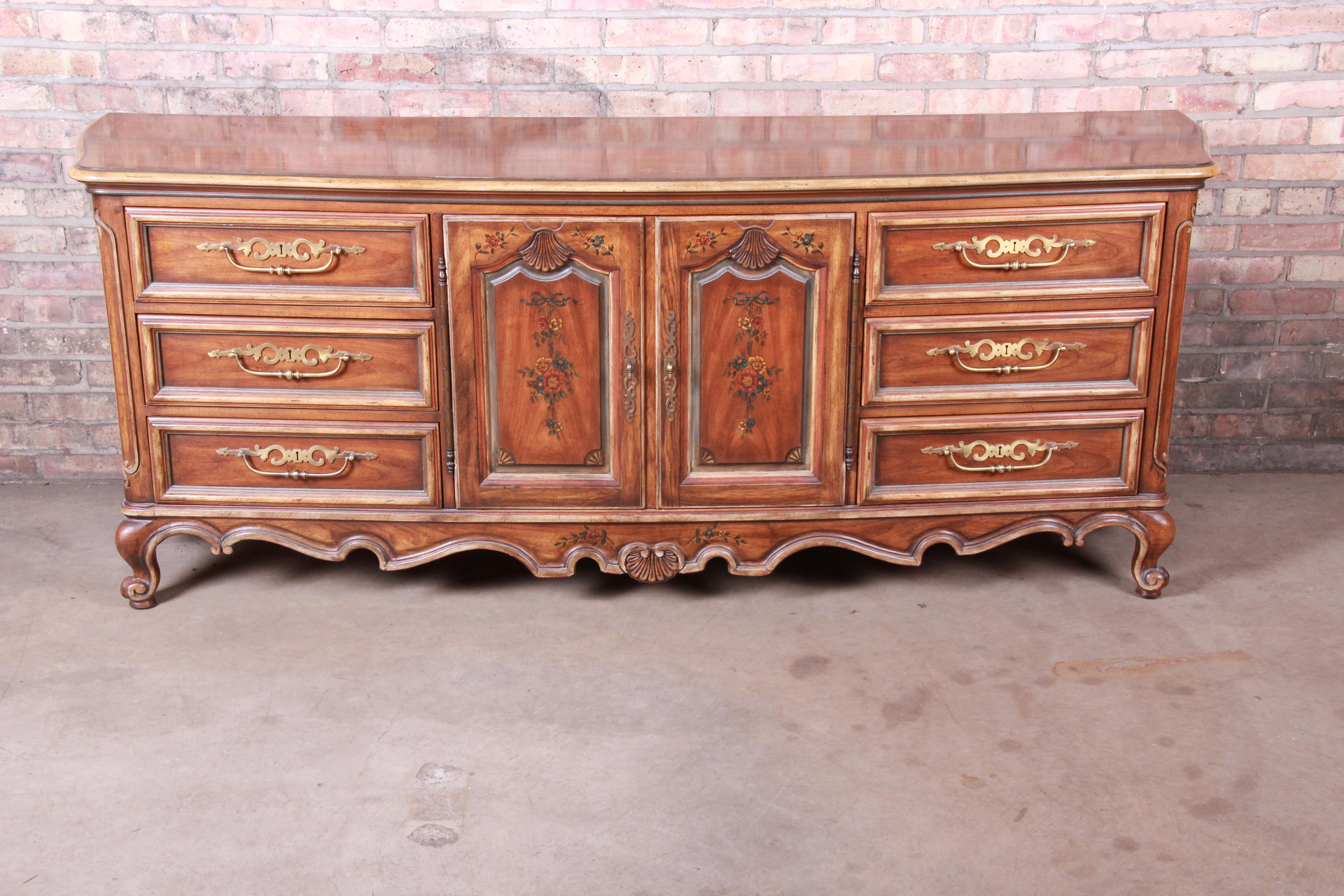 A gorgeous French Provincial Louis XV style carved walnut long dresser or credenza with shell motif and painted floral accents

By Drexel Heritage 