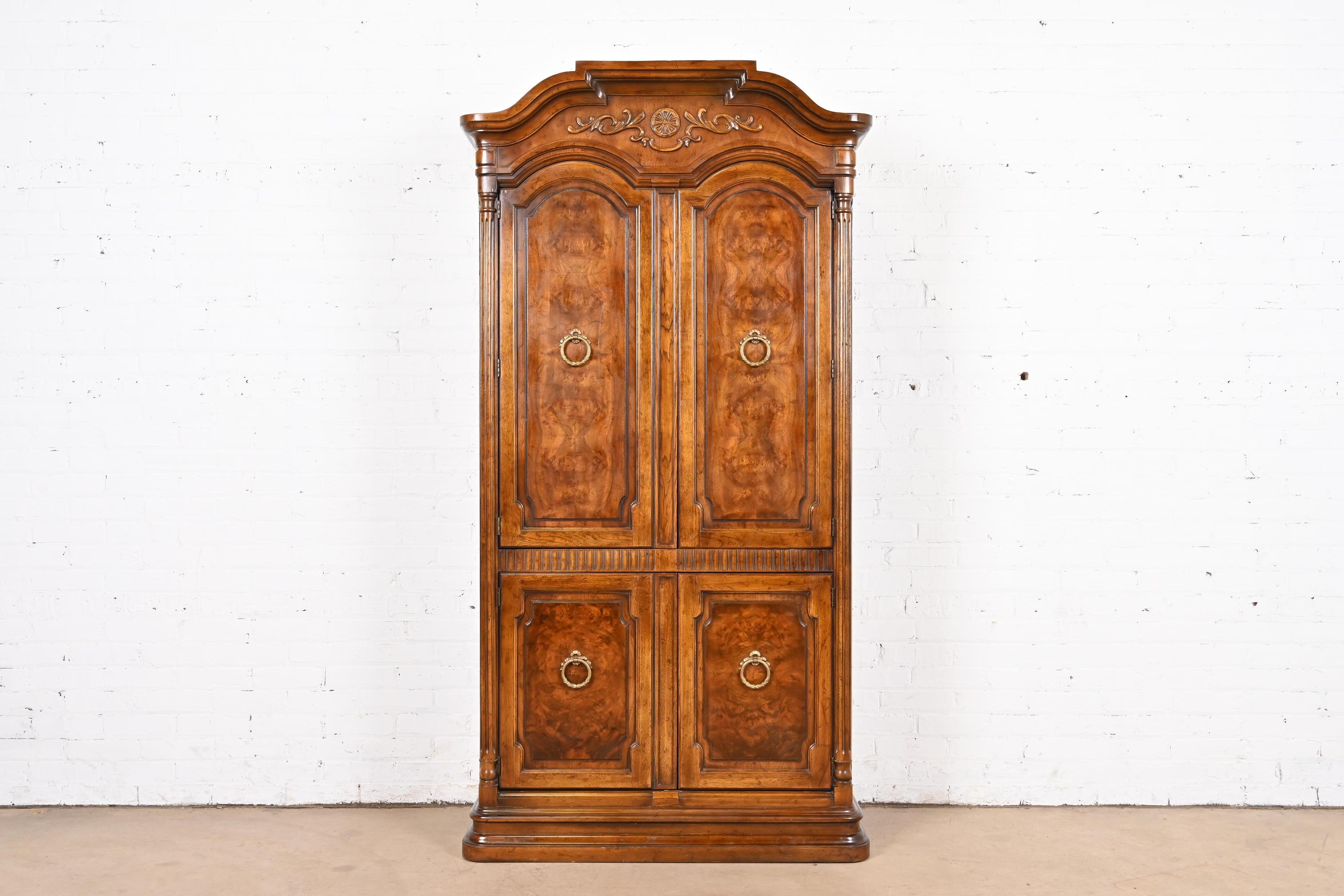 A gorgeous French Regency Louis XVI style armoire dresser, gentleman's chest, or linen press

By Drexel Heritage

USA, Circa 1970s

Carved burled walnut, with original brass hardware.

Measures: 40.5