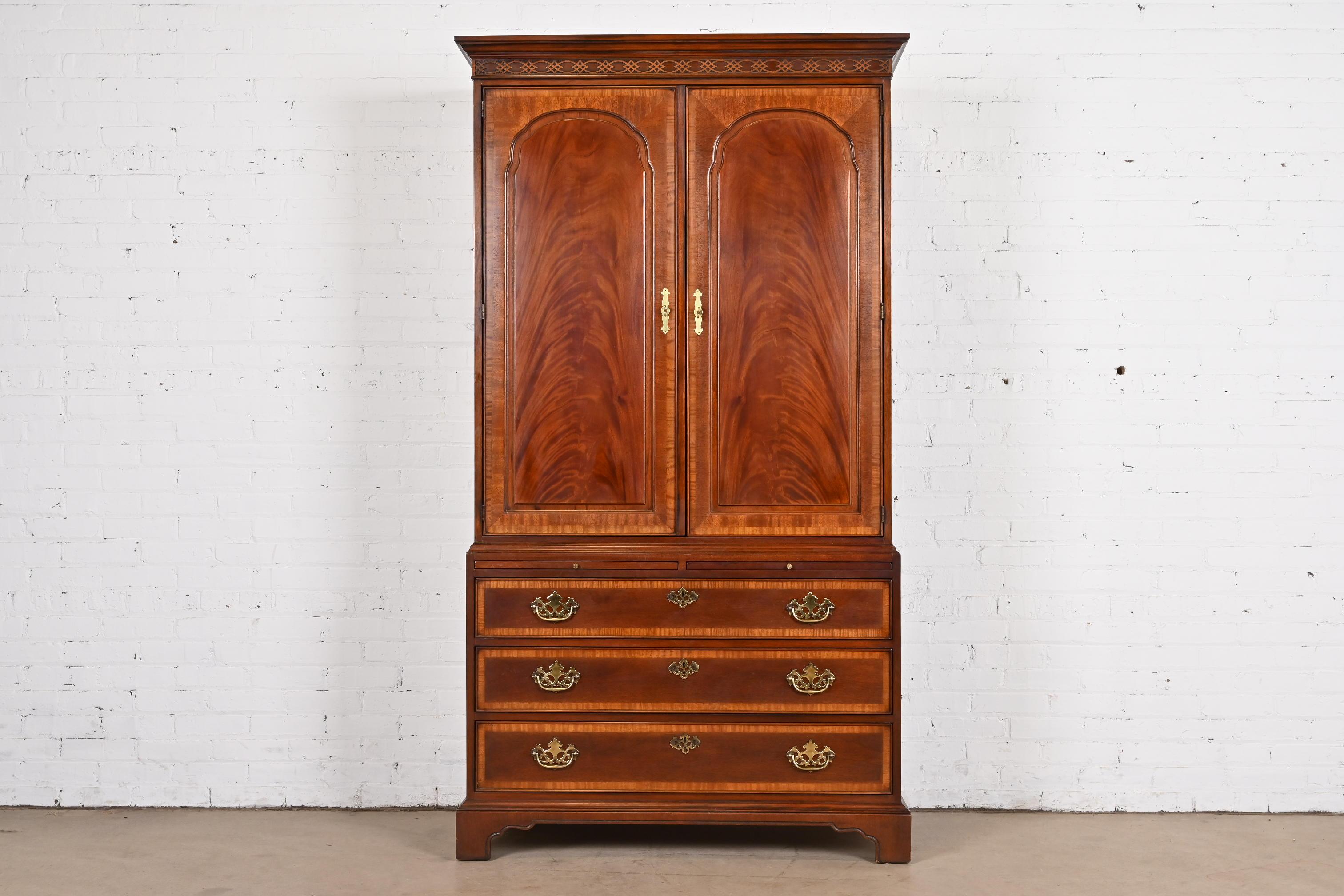 A gorgeous Georgian or Chippendale style armoire dresser or gentleman's chest

By Drexel Heritage

USA, Circa 1980s

Carved flame mahogany, with original brass hardware.

Measures: 44