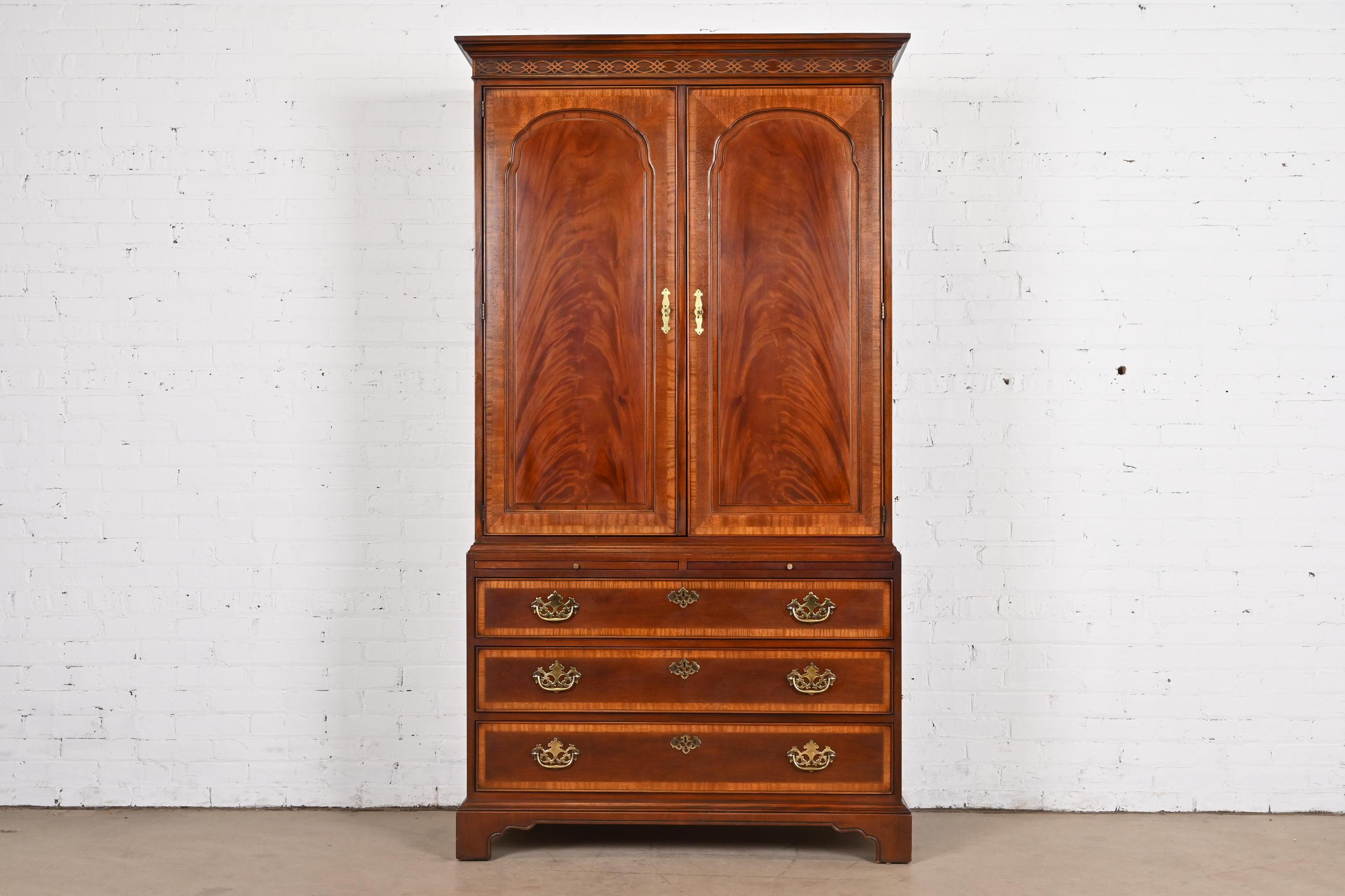A gorgeous Georgian or Chippendale style armoire dresser or gentleman's chest

By Drexel Heritage

USA, Circa 1980s

Carved flame mahogany, with original brass hardware.

Measures: 44