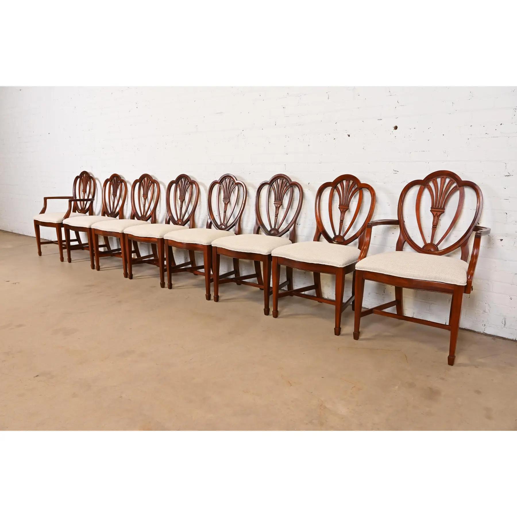 A gorgeous set of eight Federal or Hepplewhite style dining chairs

By Drexel Heritage

USA, Circa 1980s

Solid carved mahogany frames, with upholstered seats.

Measures:
Side chairs - 21