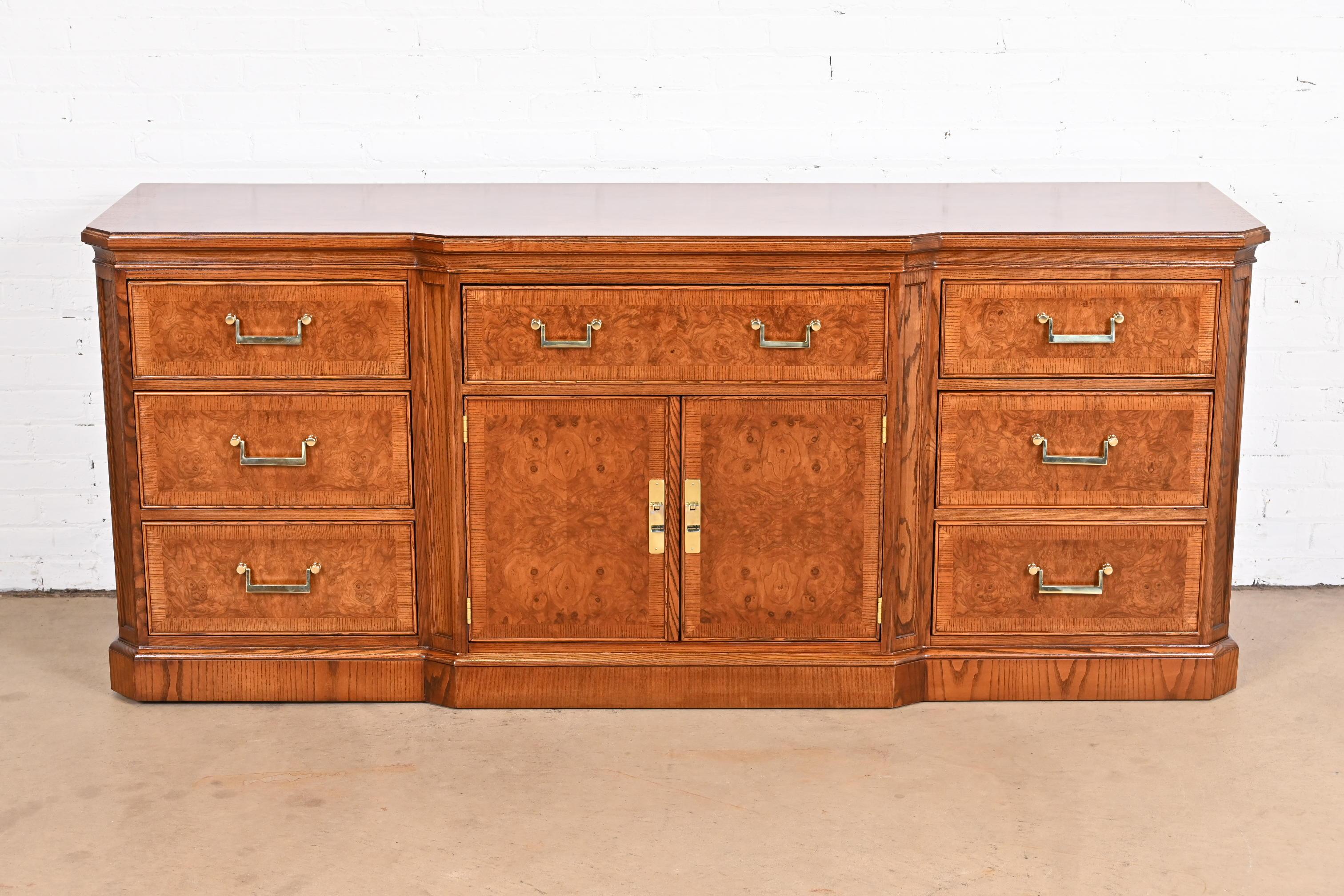 A gorgeous Mid-Century Modern Hollywood Regency nine-drawer dresser or credenza

By Drexel Heritage

USA, circa 1970s

Beautiful book-matched burled olive wood, with ash wood case, and original brass hardware.

Measures: 76