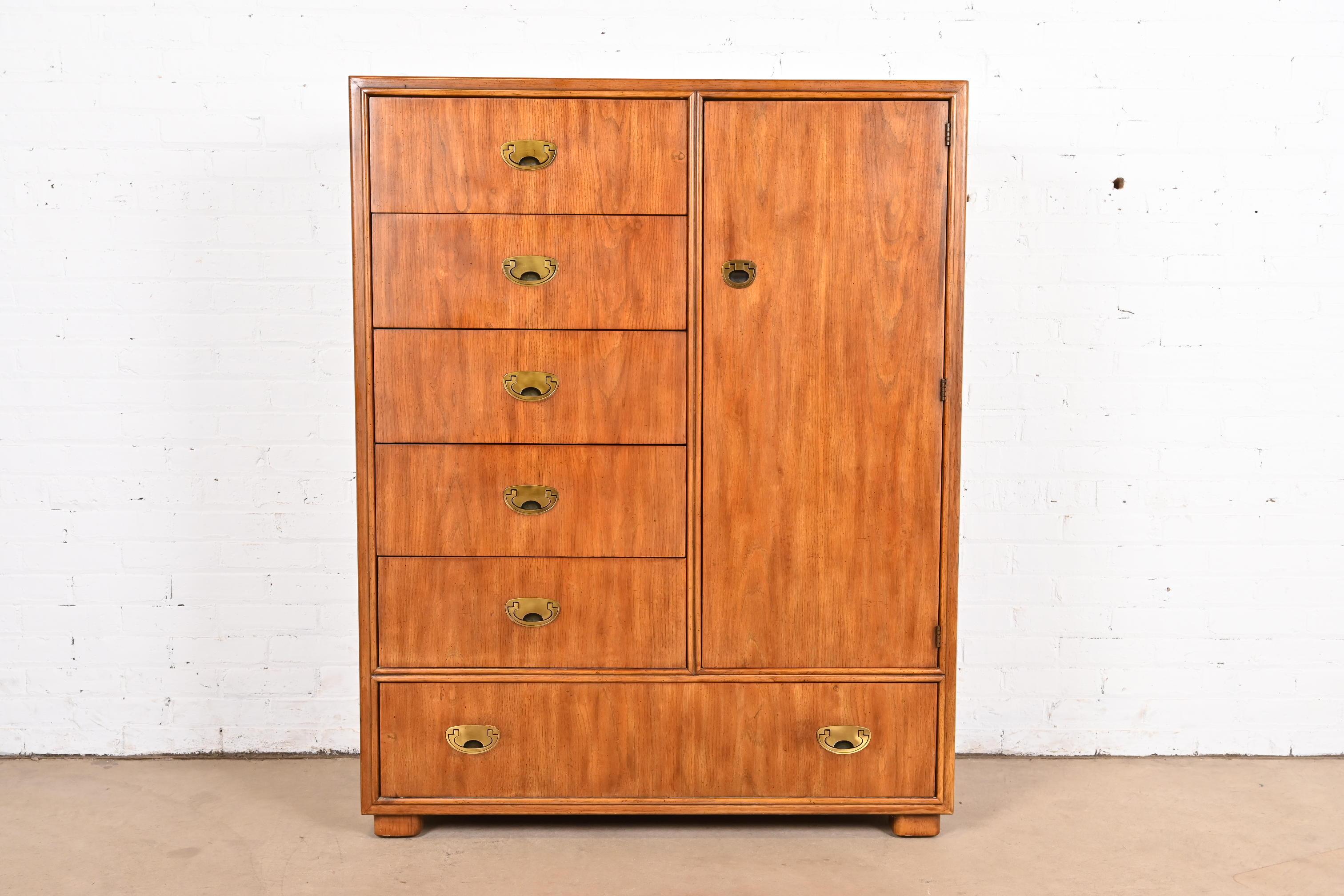 A gorgeous mid-century modern Hollywood Regency Campaign style armoire dresser or gentleman's chest

By Drexel Heritage 

USA, Circa 1980s

Oak, with original brass hardware. Shelves are adjustable

Measures: 42.75
