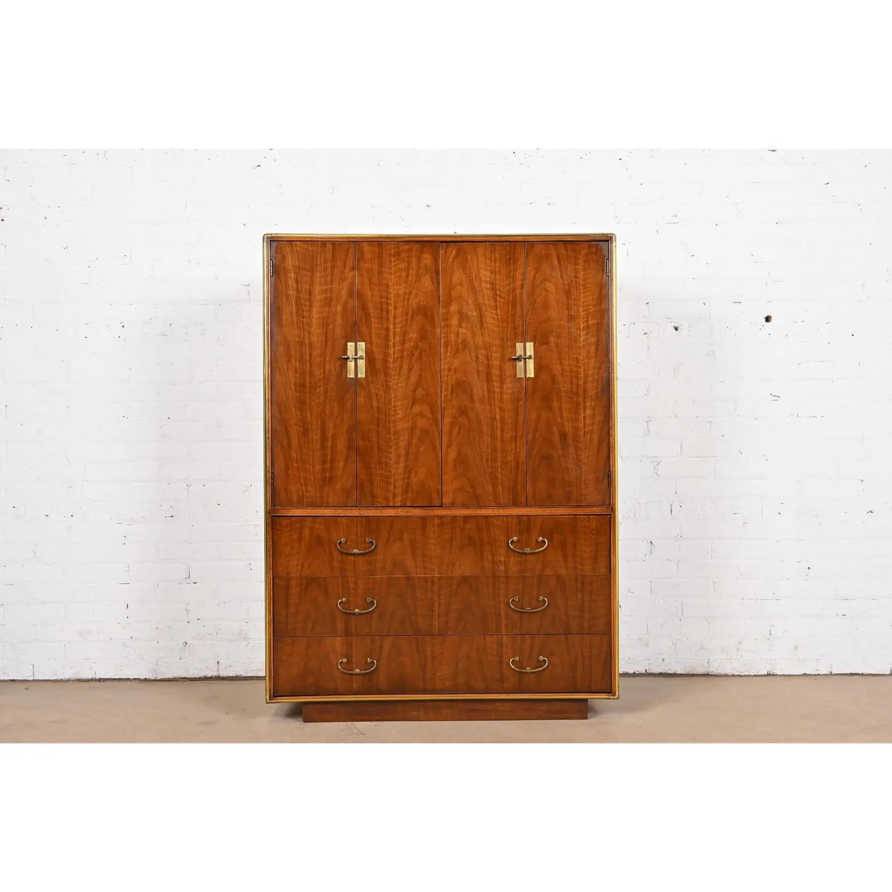 A gorgeous mid-century modern Hollywood Regency Campaign style armoire dresser, gentleman's chest, or linen press

By Drexel Heritage

USA, Circa 1970s

Beautiful book-matched walnut, with brass trim and original brass hardware. Shelves are