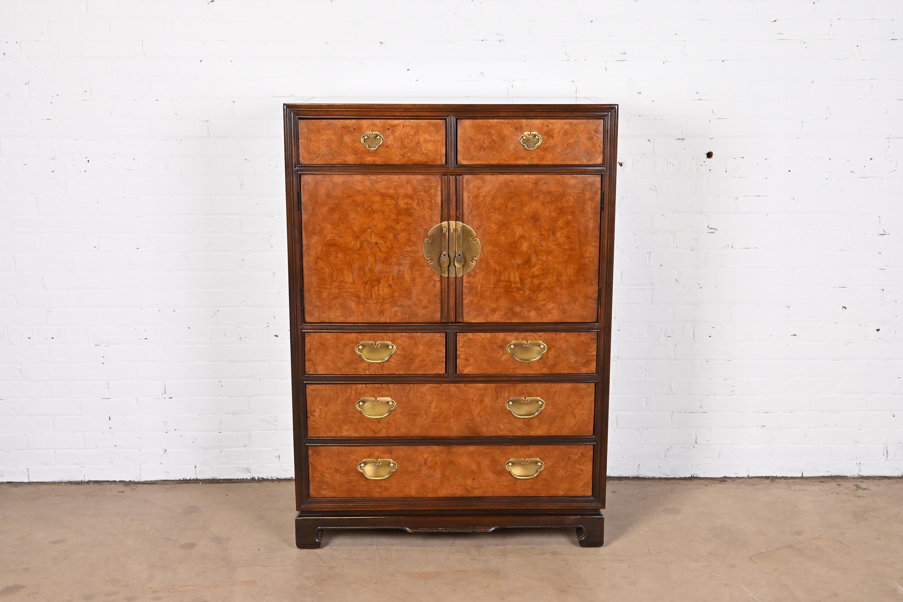 An exceptional Hollywood Regency Chinoiserie style gentleman's chest or highboy dresser

By Drexel Heritage

USA, 1983

Gorgeous burl wood front, with walnut case and banding and original Asian-inspired brass hardware.

Measures: 40