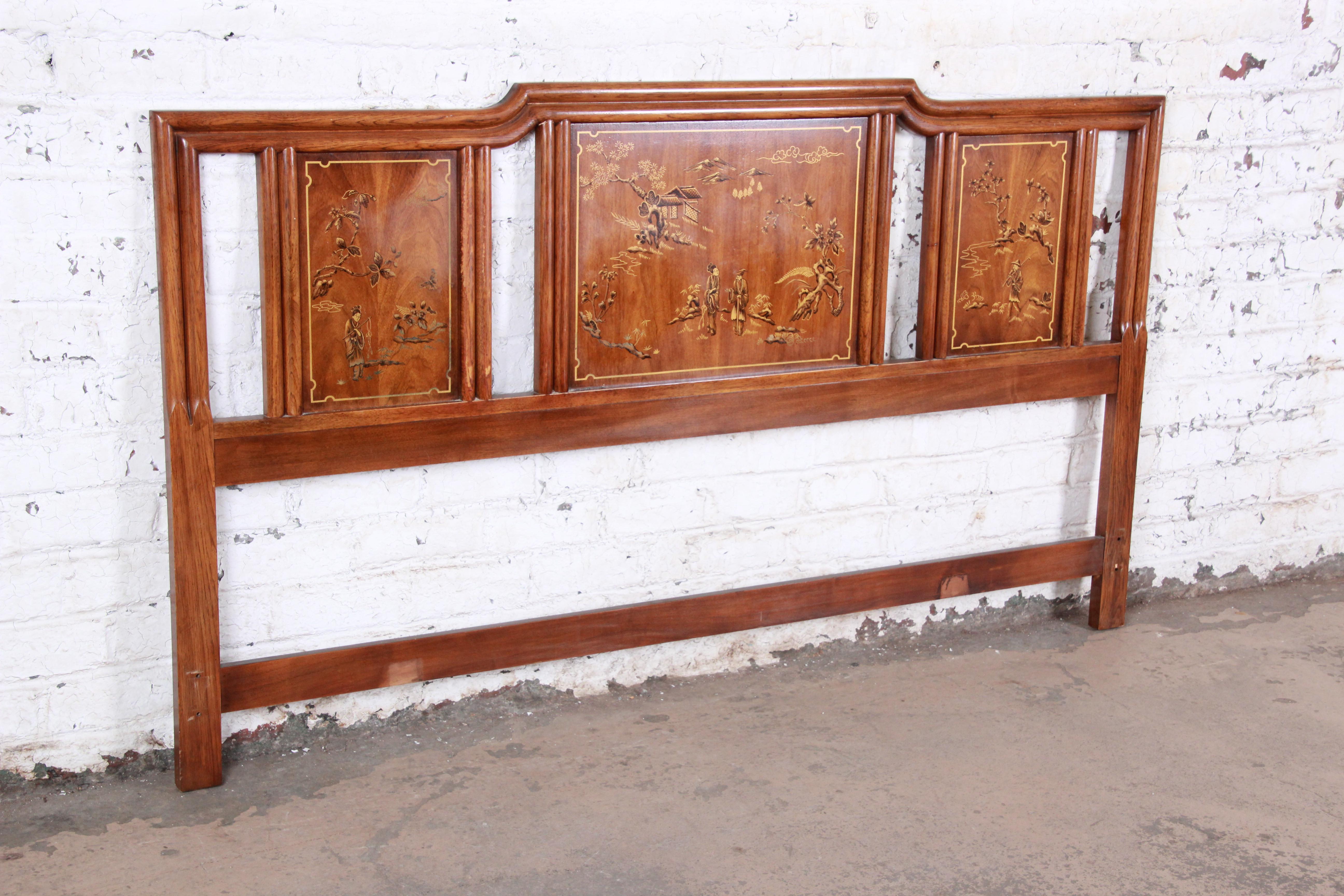 An exceptional Hollywood Regency chinoiserie king size headboard from the Dynasty Collection by Drexel Heritage. The headboard features gorgeous walnut wood grain and beautiful painted Asian nature scenes. The original label is present. It is in