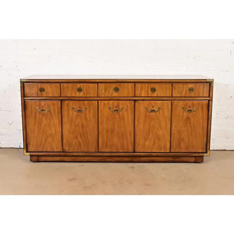 A gorgeous mid-century modern Hollywood Regency Campaign style sideboard, credenza, or bar cabinet

By Drexel Heritage

USA, Circa 1970s

Beautiful book-matched walnut, with original brass hardware.

Measures: 66.25