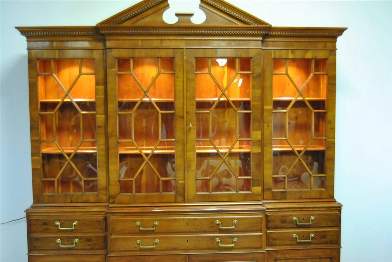 An unusual knotty cherry china display cabinet made by Drexel Heritage Furniture as part of their Heirloom Collection. The heirloom collection provided limited editions of Classic furniture. Each piece is numbered and the size of the edition is