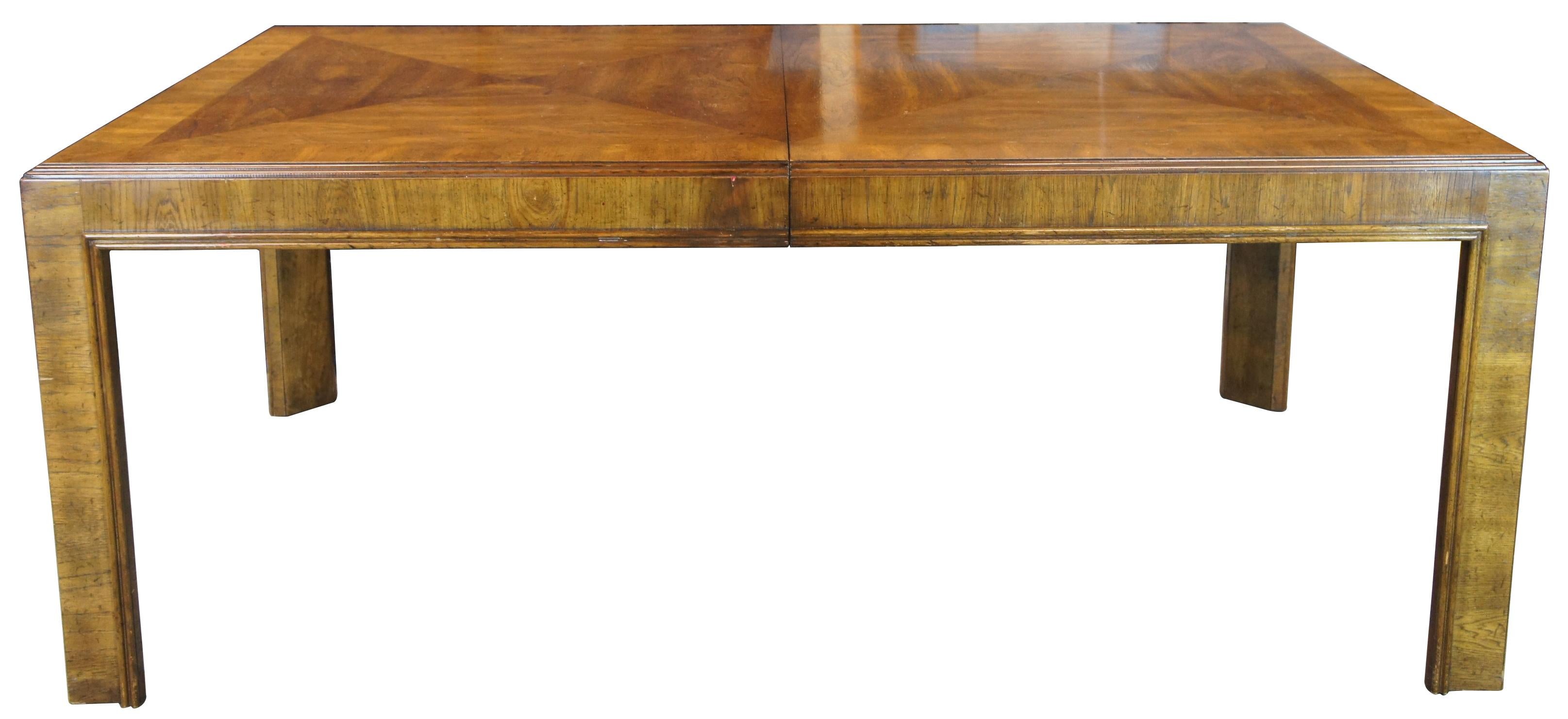 Vintage Drexel Heritage mid century modern parsons style extendable dining table. Made of walnut featuring rectangular form with matchbook top and three large extendable leaves. 955-344-34 - 475.

Measures: 45