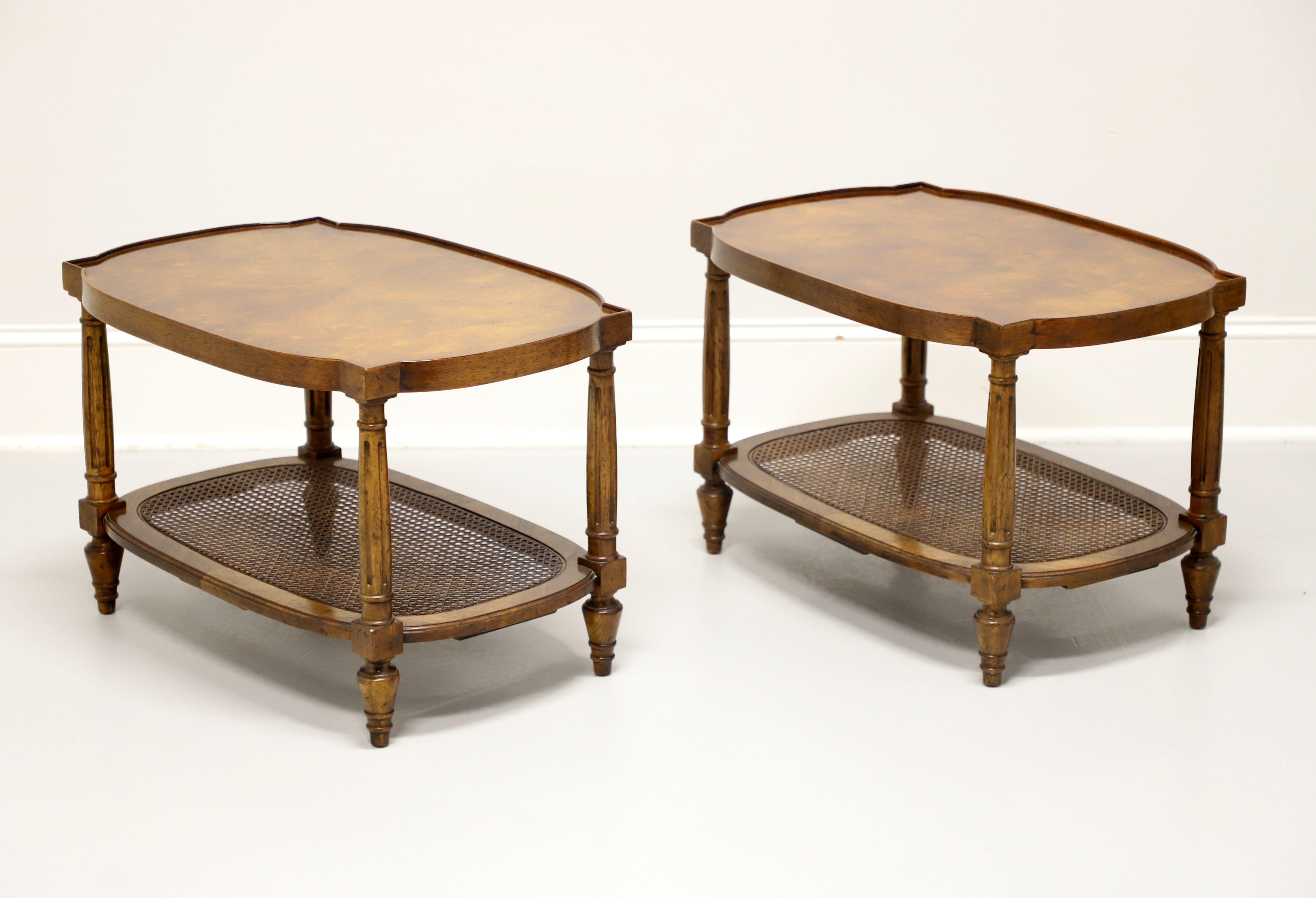A pair of French Regency style cocktail tables by Drexel Heritage. Walnut with two tiers, burl walnut top with low gallery edge, caned undertier shelf, fluted legs, and turnip feet. Made in North Carolina, USA, in the mid 20th century.

Style #: