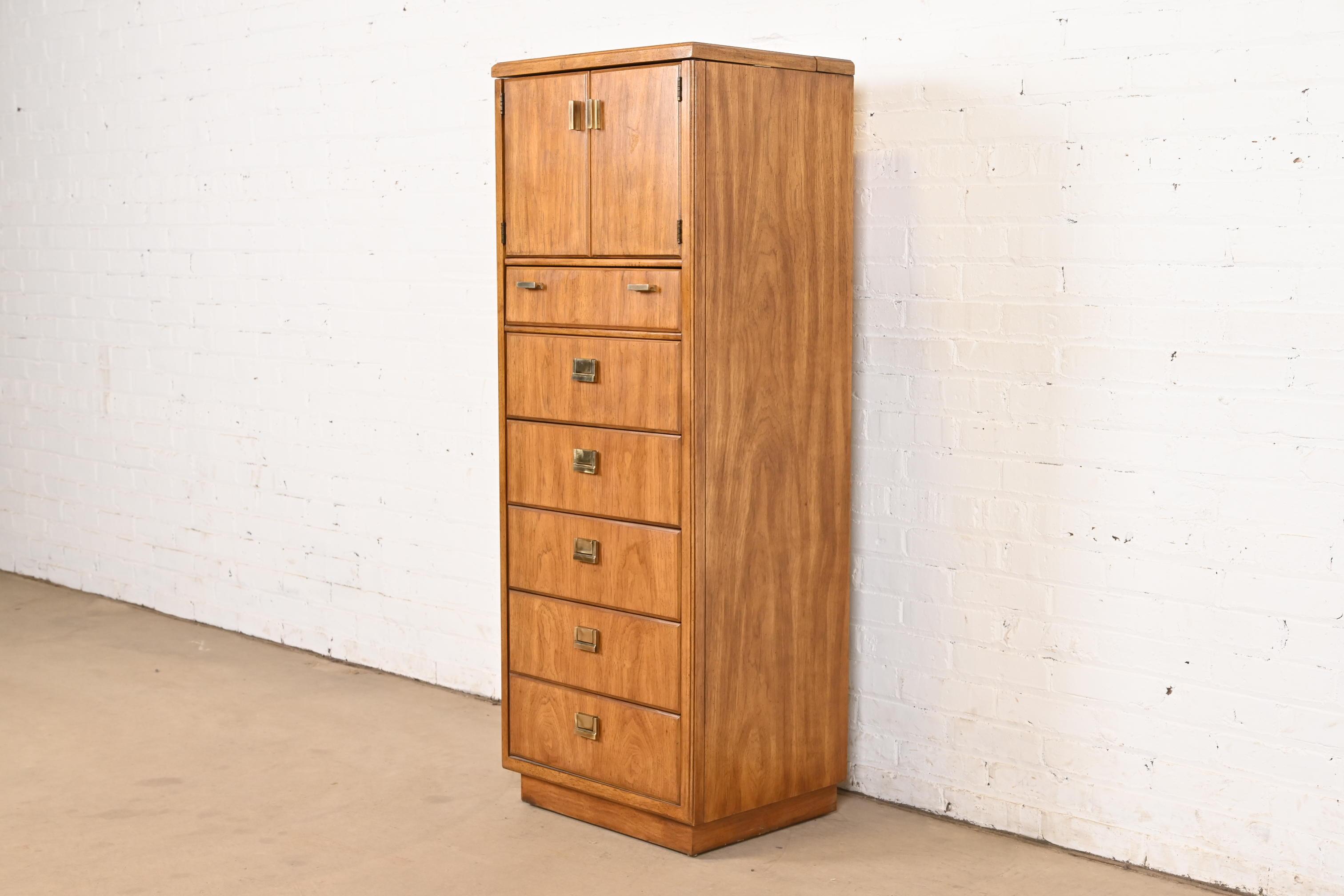 A gorgeous mid-century modern Hollywood Regency Campaign style gentleman's chest or lingerie chest with flip-up vanity mirror

By Drexel Heritage

USA, Circa 1970s

Walnut, with lift-up mirror, and original brass hardware. 

Measures: 20.25
