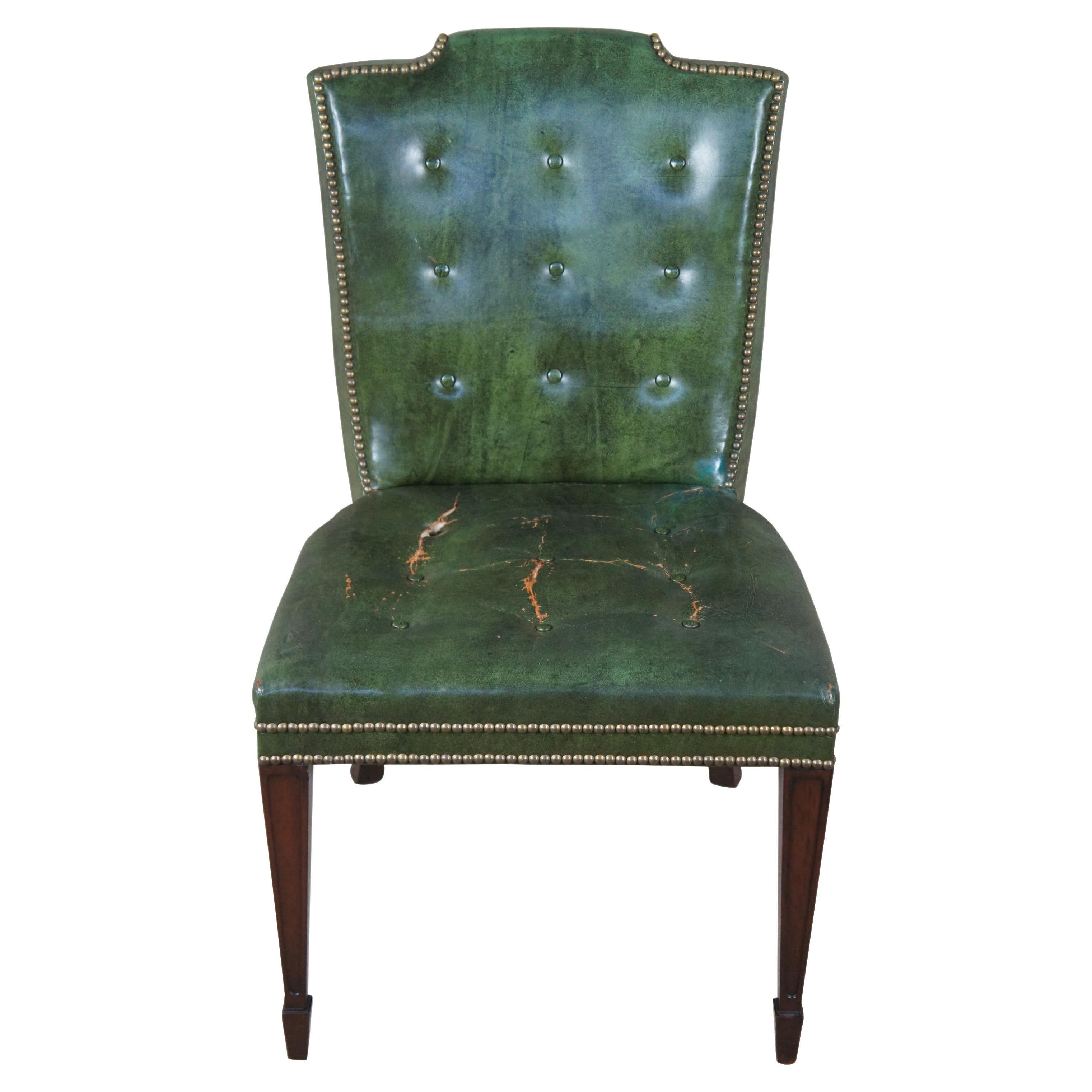 A Stunning side or desk chair by Heritage Furniture, circa 1950s. Heritage later became Drexel Heritage. Features a mahogany frame inspired by Sheraton and federal styling with a contoured back, upholstered in green leather with button tufting and