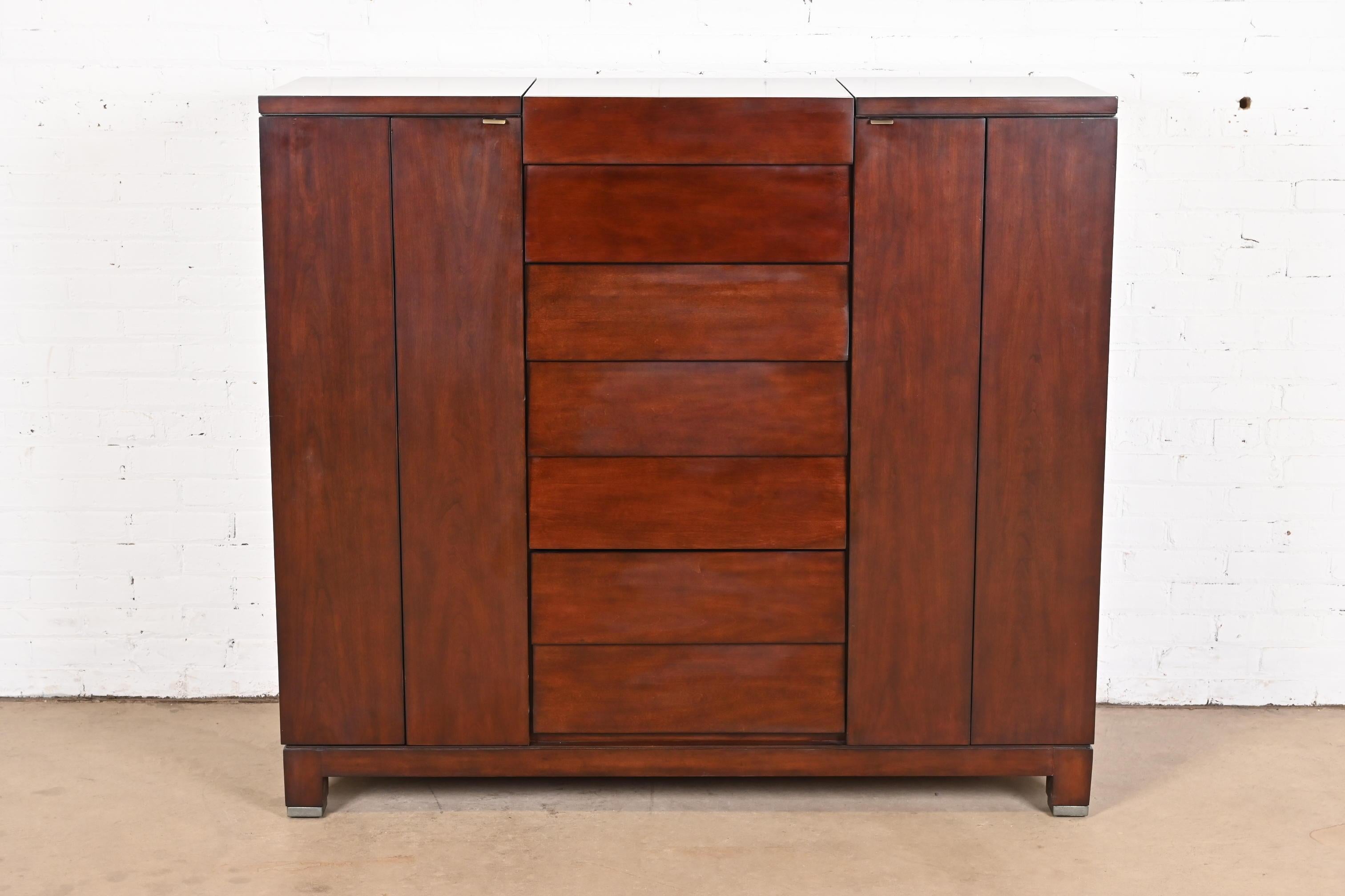 A gorgeous Modern gentleman's chest or chifferobe

By Drexel Heritage

Circa Late 20th Century

Cherry wood, with flip up mirror.

Measures: 57.25