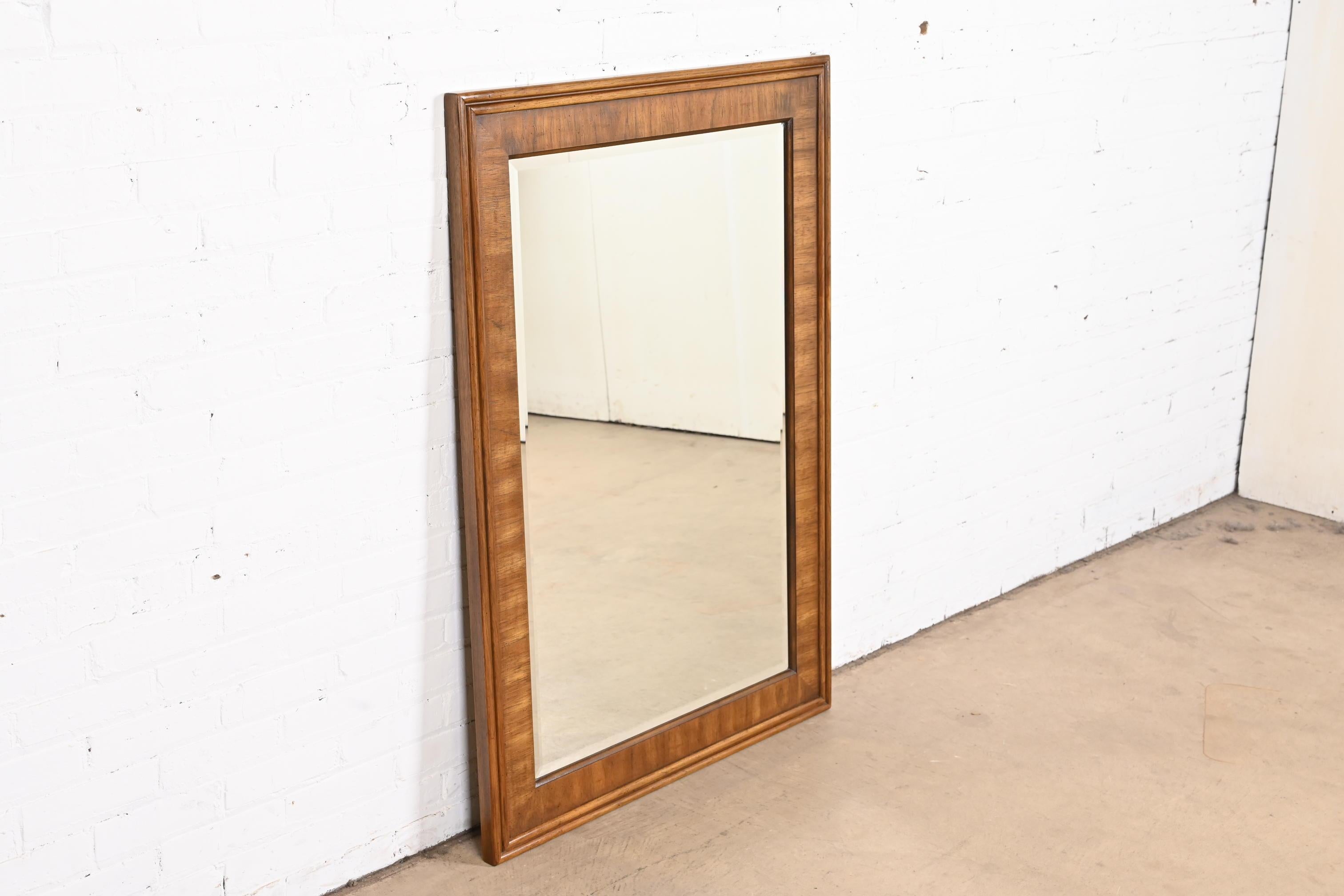 A gorgeous Modern walnut framed large beveled glass mirror.

By Drexel Heritage.

USA, 1980s

Measures: 33.63