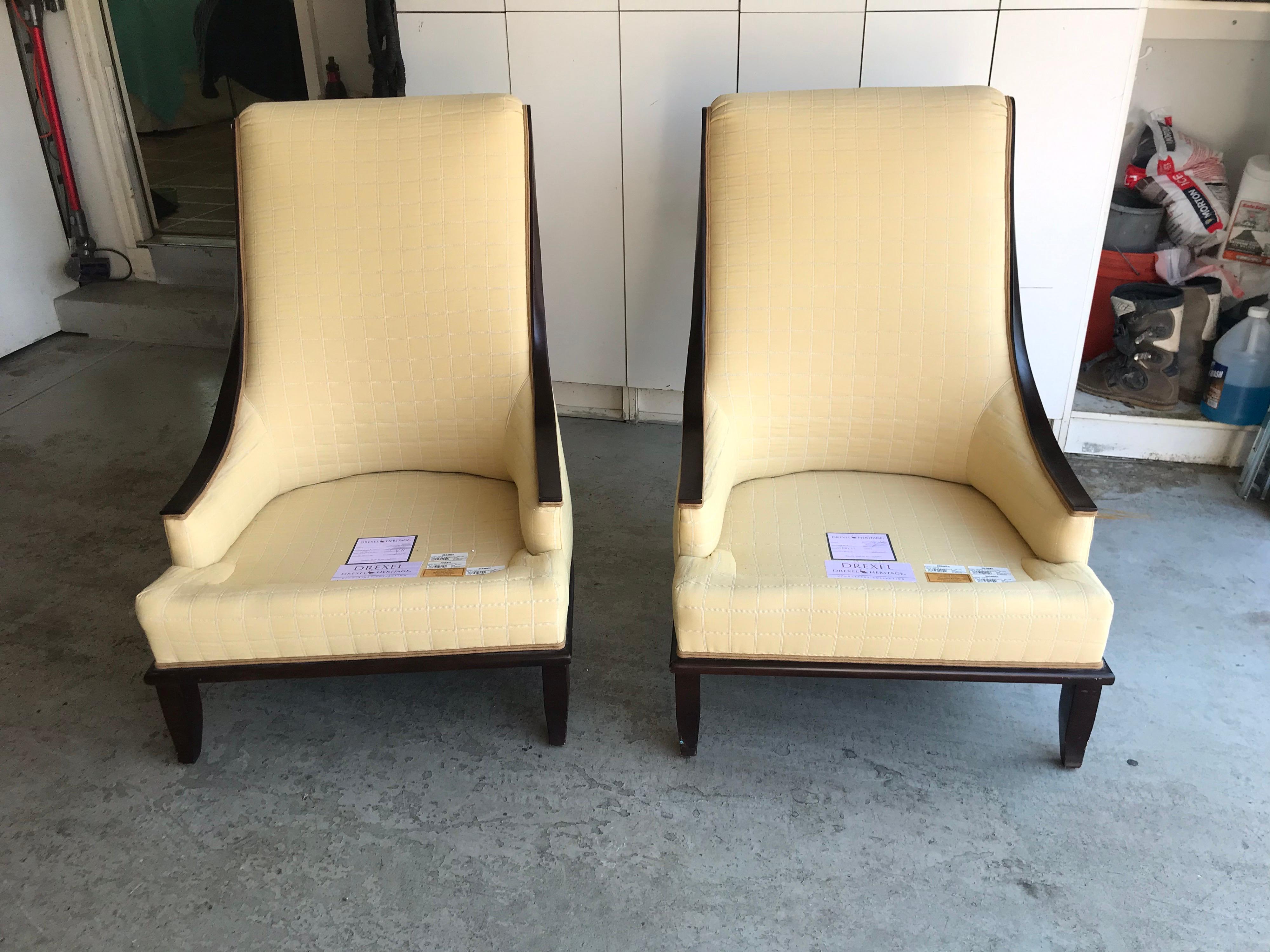 This is a pair of lovely shaped Drexel heritage upholstered chairs 
The upholstery is in a butter yellow and in great vintage condition The chairs are incredibly comfortable.