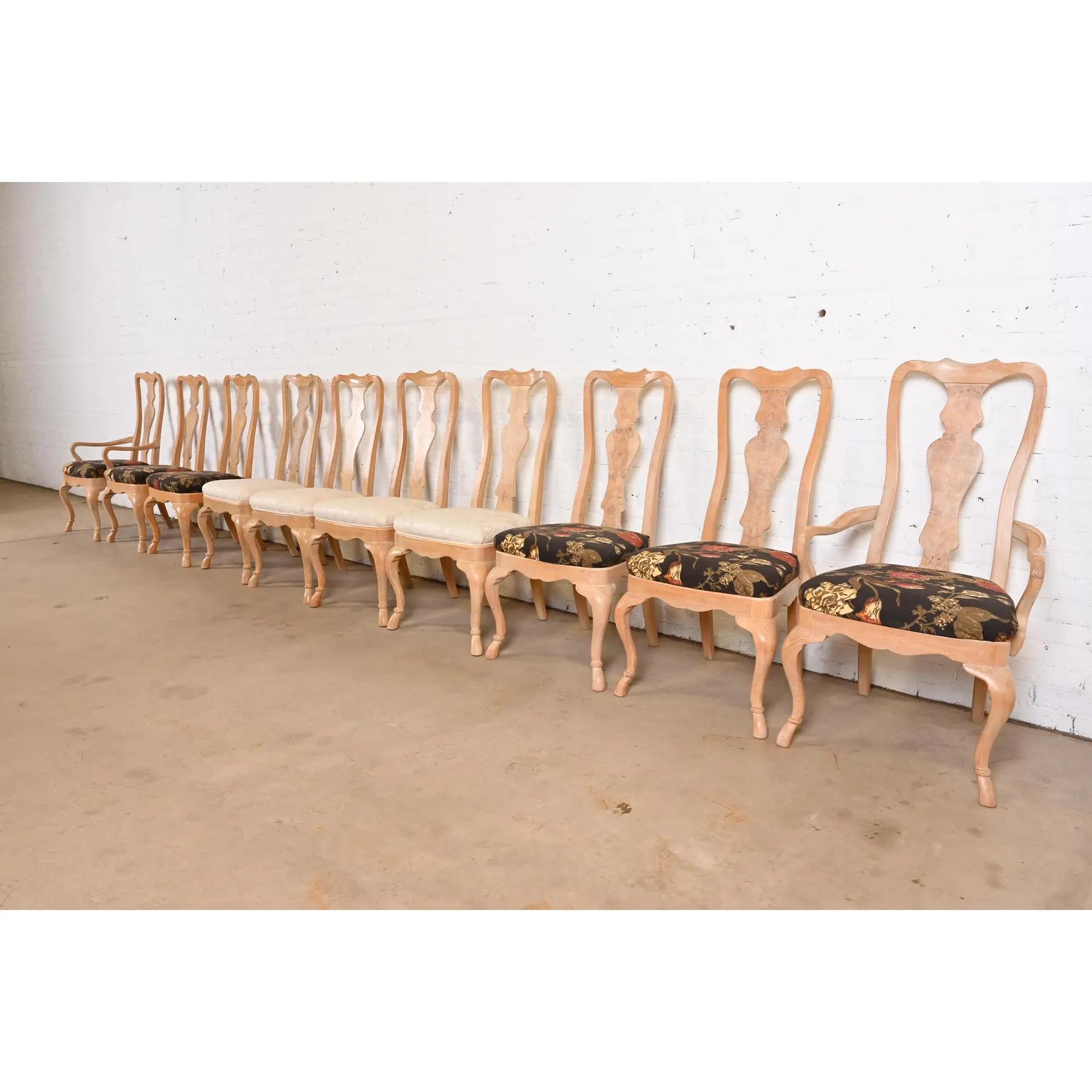 A gorgeous set of ten Queen Anne or Georgian style dining chairs

By Drexel Heritage

USA, Late 20th Century

Carved oak, with burled olive wood backs, and upholstered seats.

Measures:
Side Chairs: 21.5