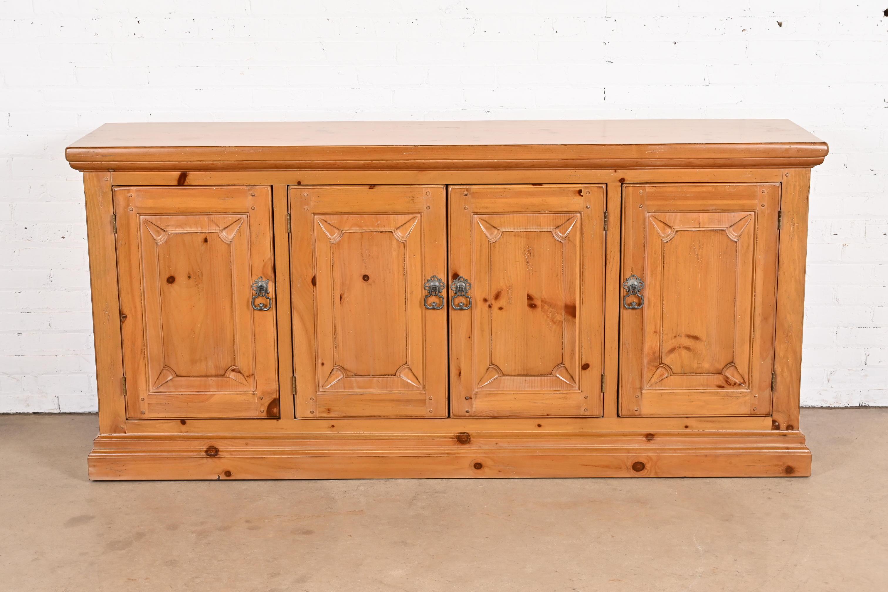 A gorgeous Spanish Colonial style sideboard, credenza, or bar cabinet

By Drexel Heritage

USA, Late 20th Century

Carved solid pine, with original brass hardware.

Measures: 79.5