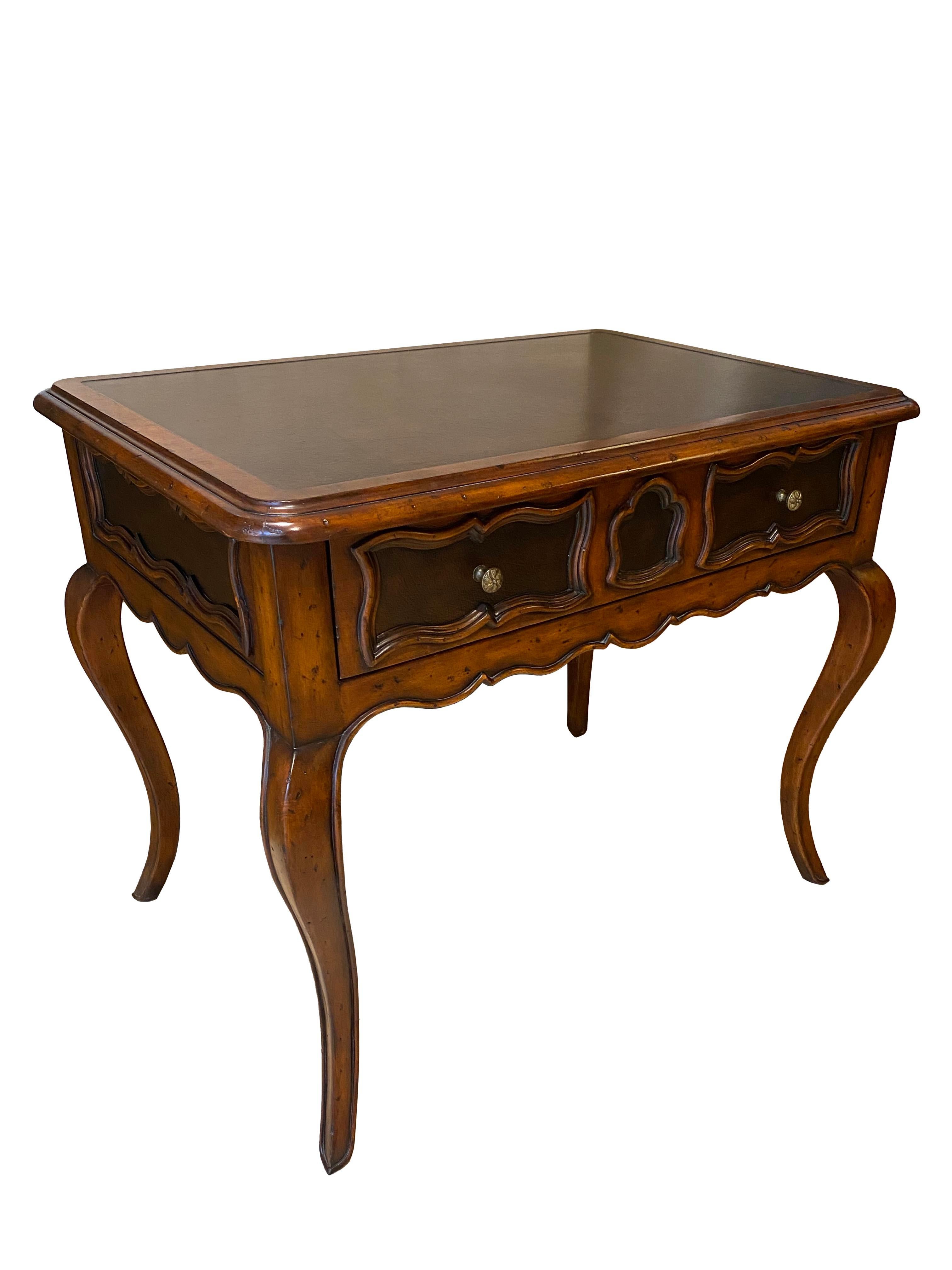 This beautifully crafted wood side table combines classic elegance with rustic charm, making it a versatile addition to any space. The tabletop features a rich leather inlay, offering a luxurious contrast in texture and color, while coordinating