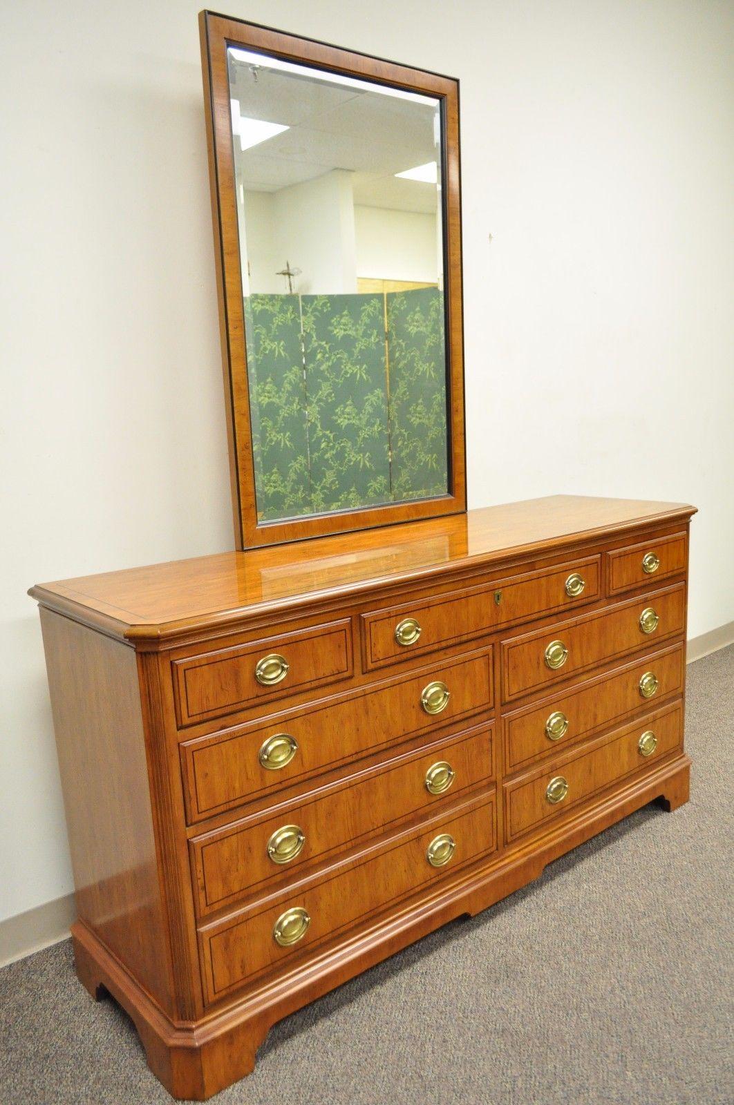 Drexel Heritage Yorkshire long dresser with matching mirror. Item features - Heavy solid construction, yew wood, seven dovetail constructed drawers, solid brass hardware, original glossy finish, banded, ebony inlay, beveled glass mirror, circa late