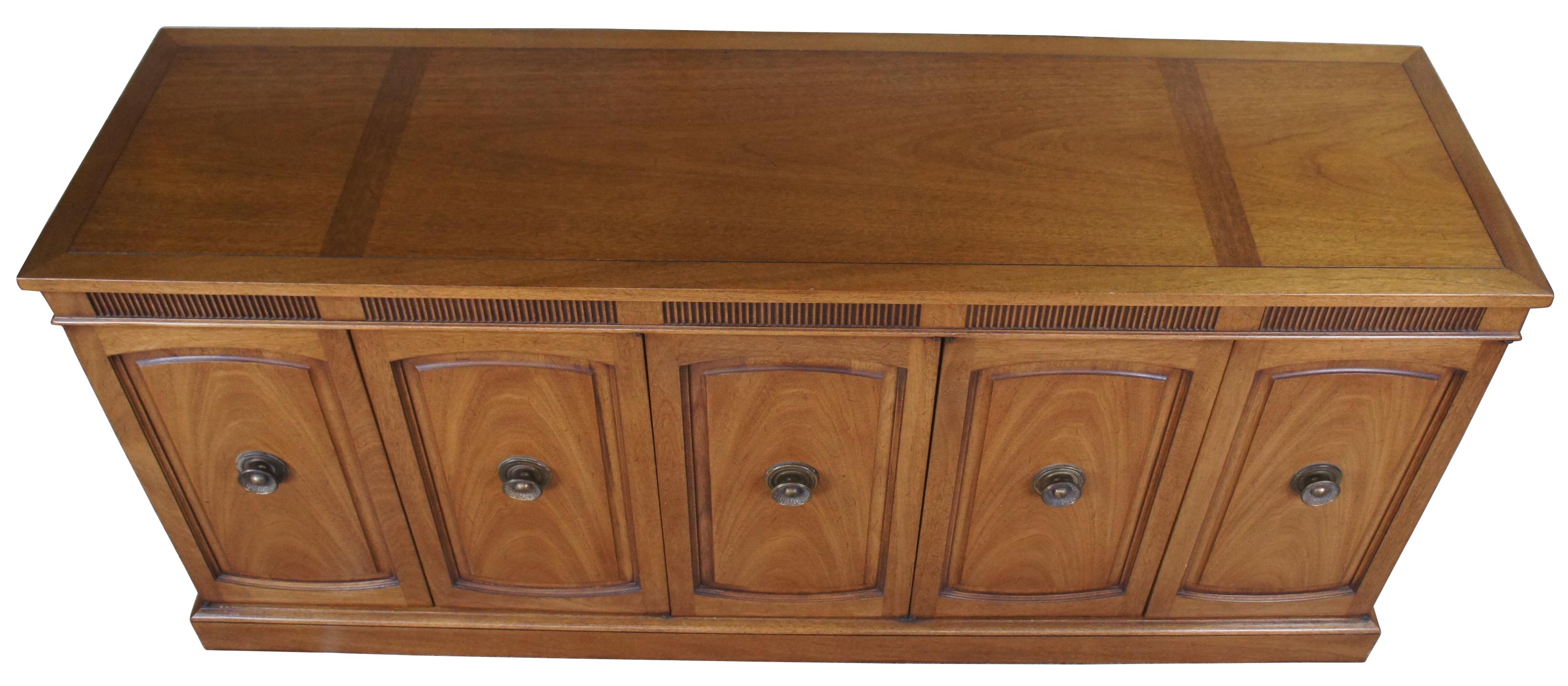 Italian Provincial sideboard/ server by Drexel Heritage, circa 1961. Part of their Triune collection, finished in Mahogany. Features a rectangular form sporting a Tuscan inspired design with a fluted apron, paneled doors and brass hardware. Includes