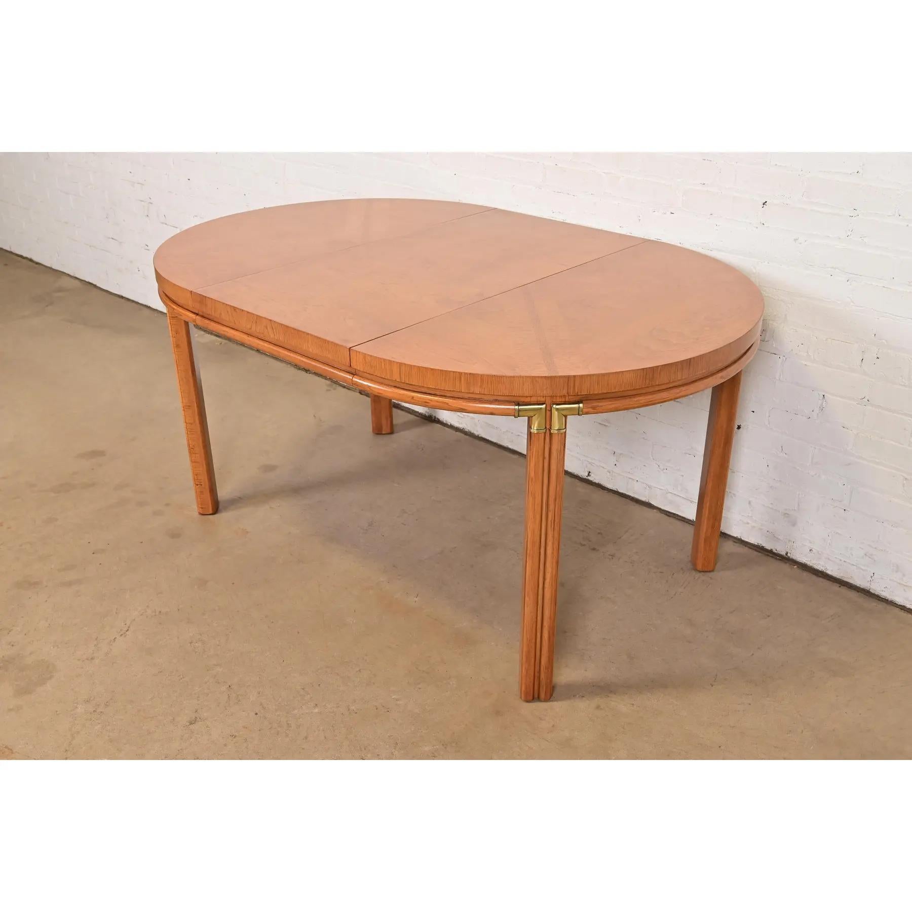 A gorgeous Mid-Century Modern Hollywood Regency Campaign extension dining table

By Drexel 

USA, Circa 1960s

Beautiful book-matched pecan wood, with brass accents.

Measures: 40