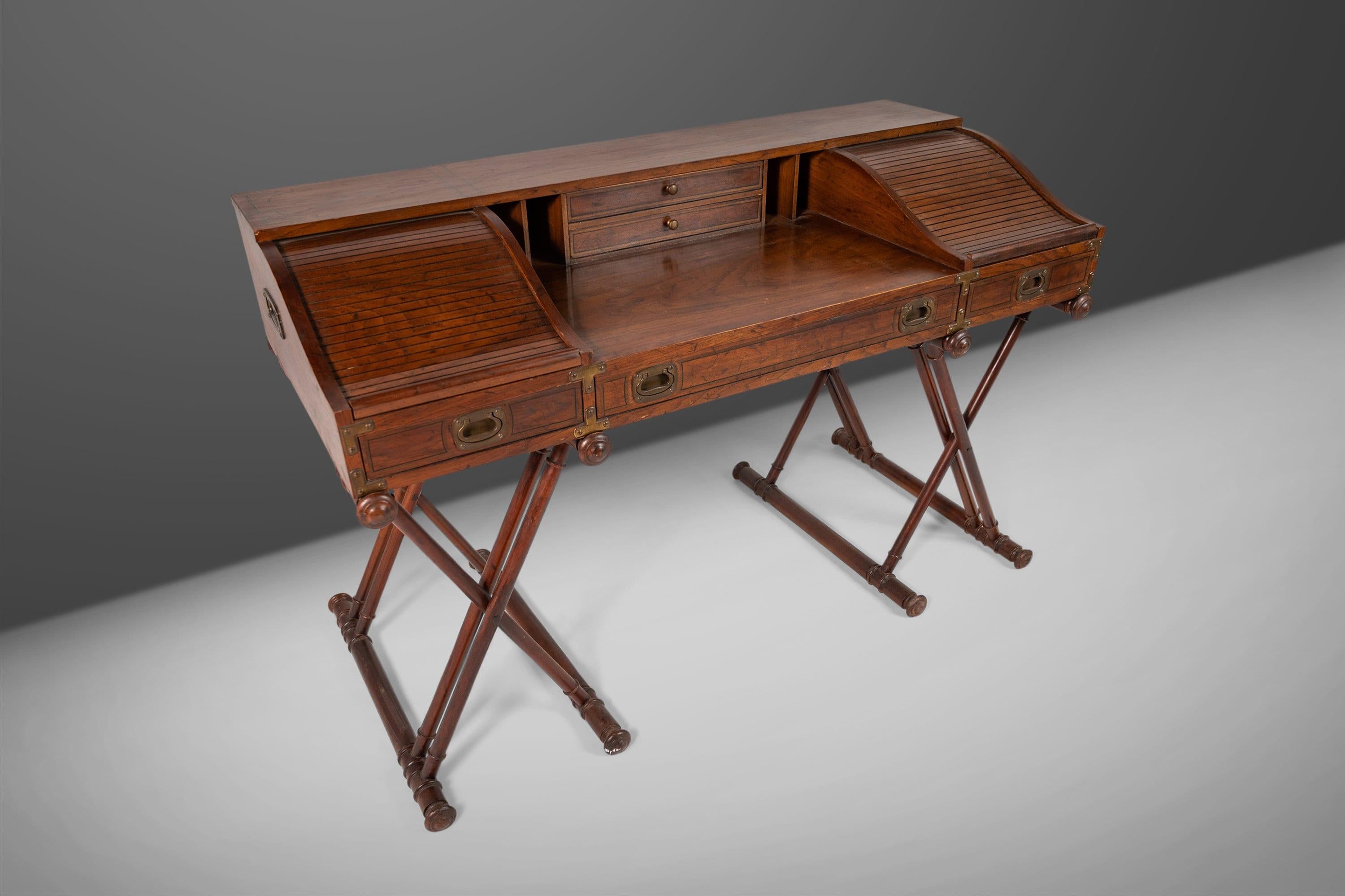 Dazzlingly sumptuous, if a bit boisterous, this campaign style desk was made by Drexel as part of their 'Oxford Square' Collection. It has all of the bells and whistles, and a few surprises too. The overall look of the piece is very British, c. 19th