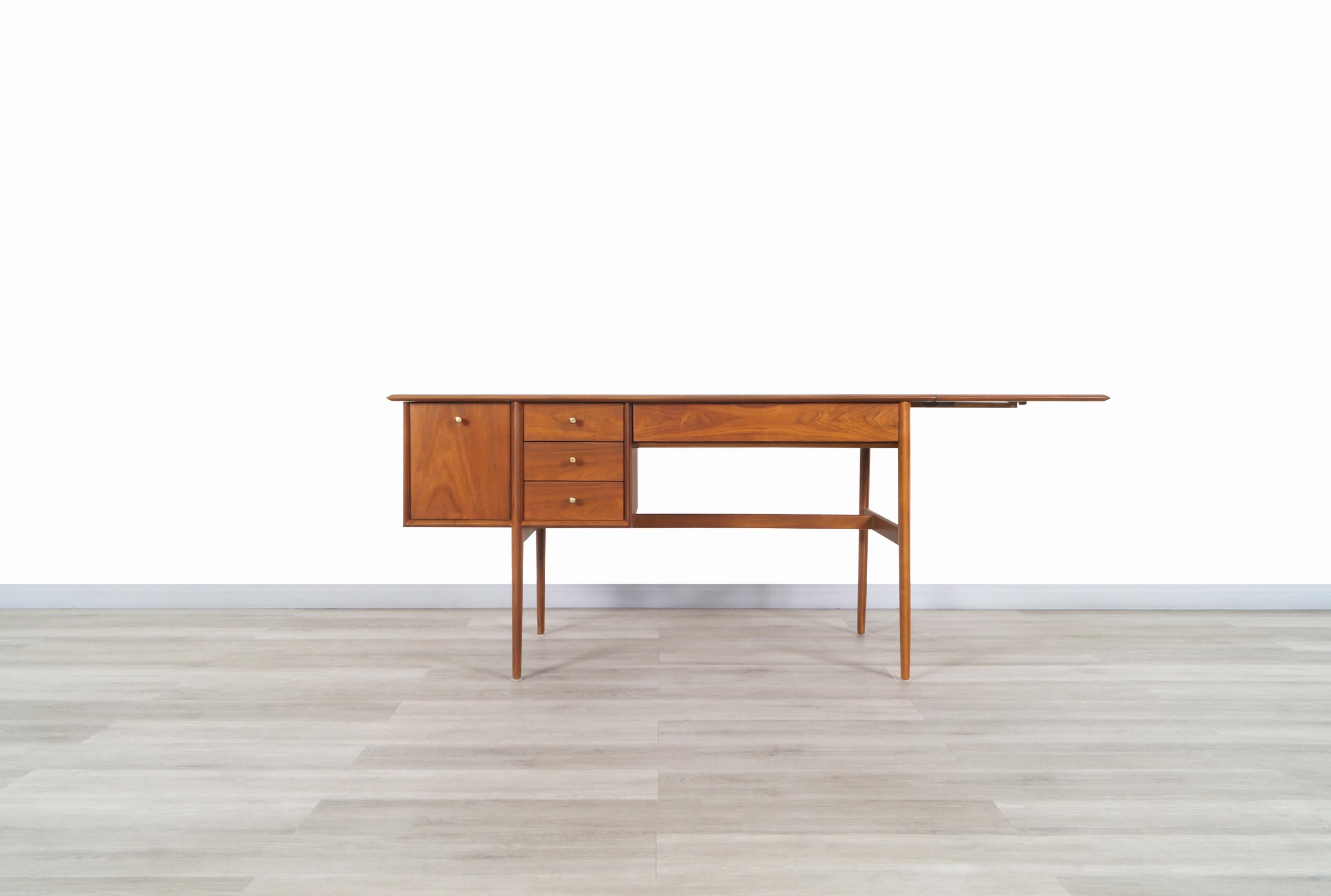 Fabulous vintage writing desk designed by Barney Flagg for Drexel Furniture in the United States, circa 1960s. This desk is made from walnut wood and belongs to the Drexel 