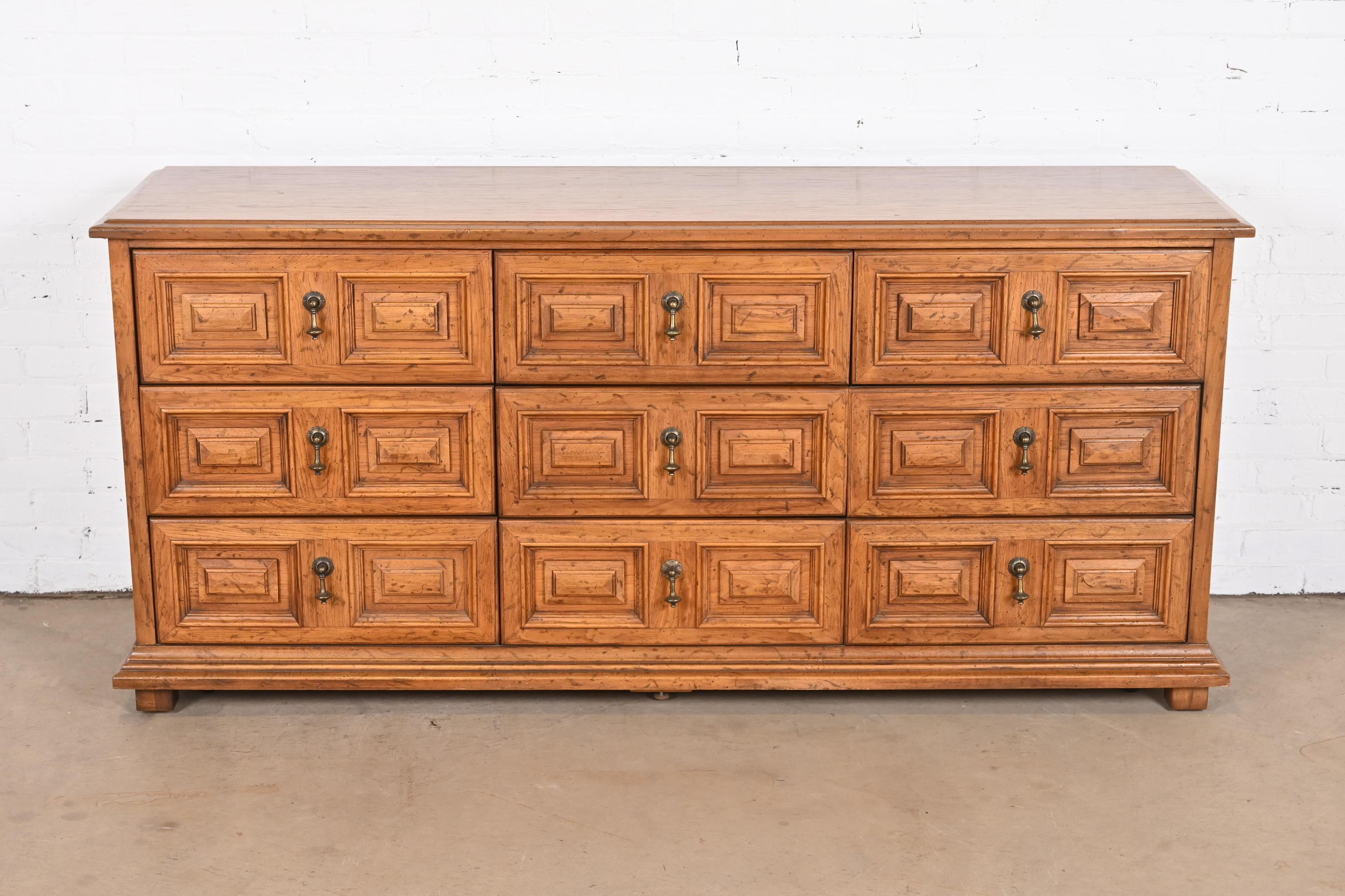 A gorgeous Spanish Colonial style nine-drawer triple dresser or credenza

By Drexel, 