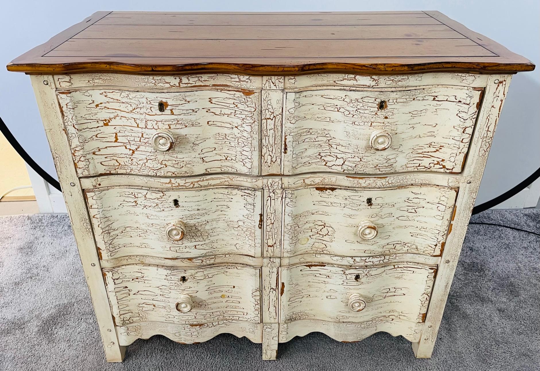 An exquisite French country style nightstand, chest or commode by Drexel Studio. The chest offers 3 drawers for storage and features a wooden pine top while the chest is finished in a distressed cream color. The chest or nightstand is finely carved
