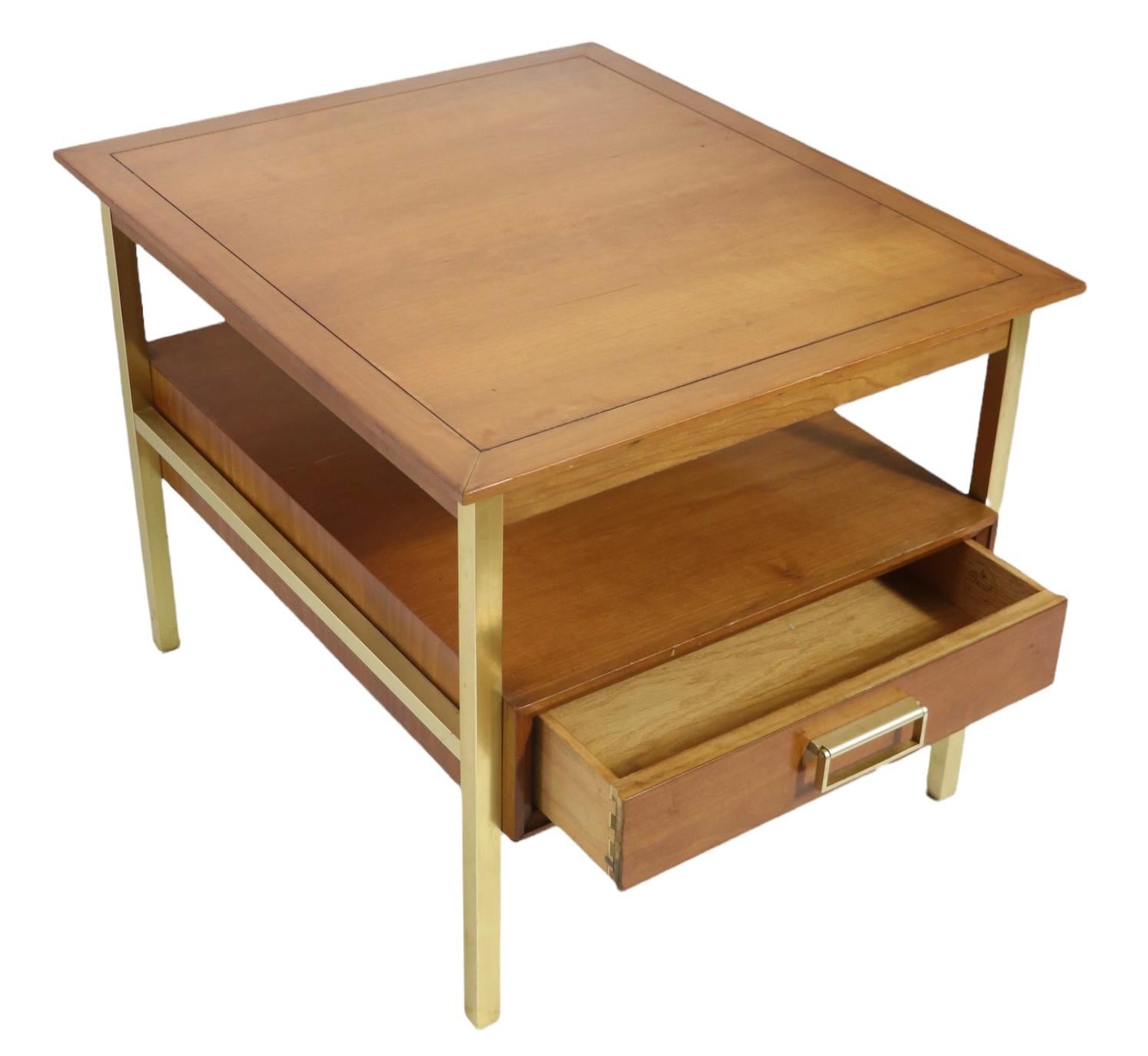 Smart, sophisticated and stylish side, or end table designed by Kipp Stewart four Drexel as part of the classic Suncoast series. This table features two tiers, the lower ( 13 in H ) has a large drawer, the upper ( 21 in. H ) has a slight overhang