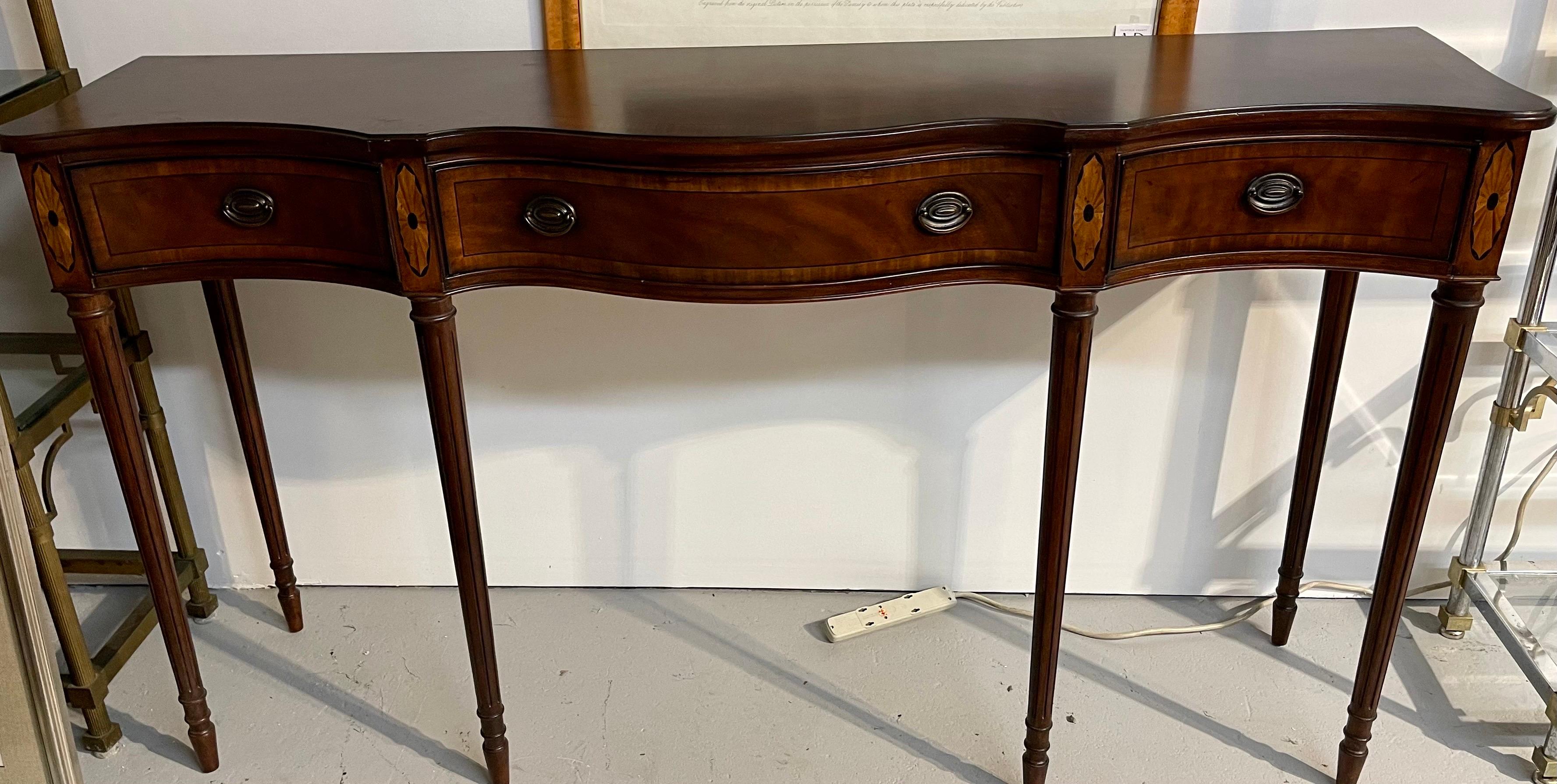 A large, tall and elegant Drexel three drawer mahogany console with inlay.
The drawers feature felt lining for your silverware. The inlay is subtle but tres
elegant. Note the dimensions, this is a large piece and taller (39