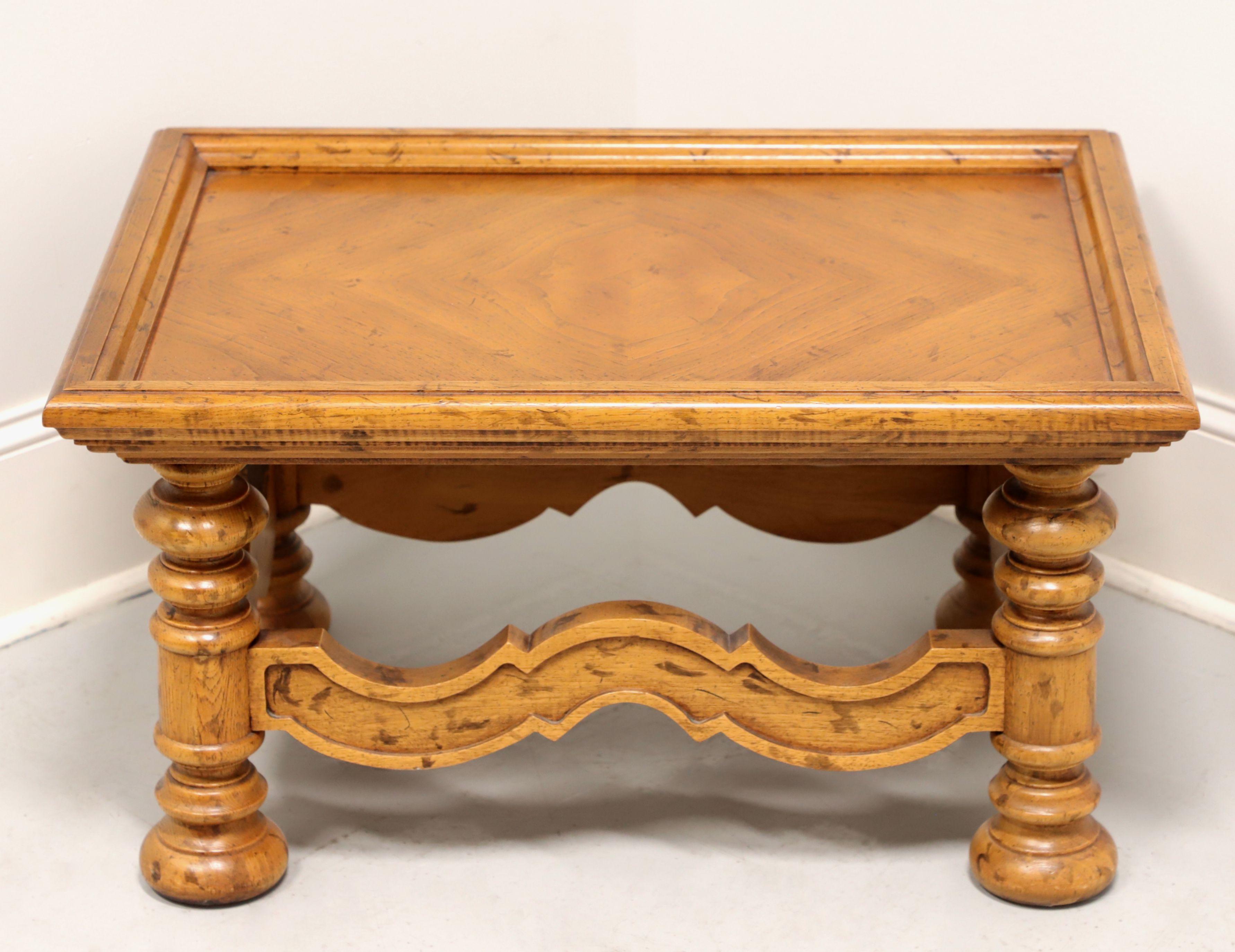 A Spanish style rectangular coffee table by Drexel, from their Velero Collection. Pecan with distressed finish, parquetry tray top, decoratively carved stretchers and turned legs. Made in North Carolina, USA, circa 1969. 

Style #: