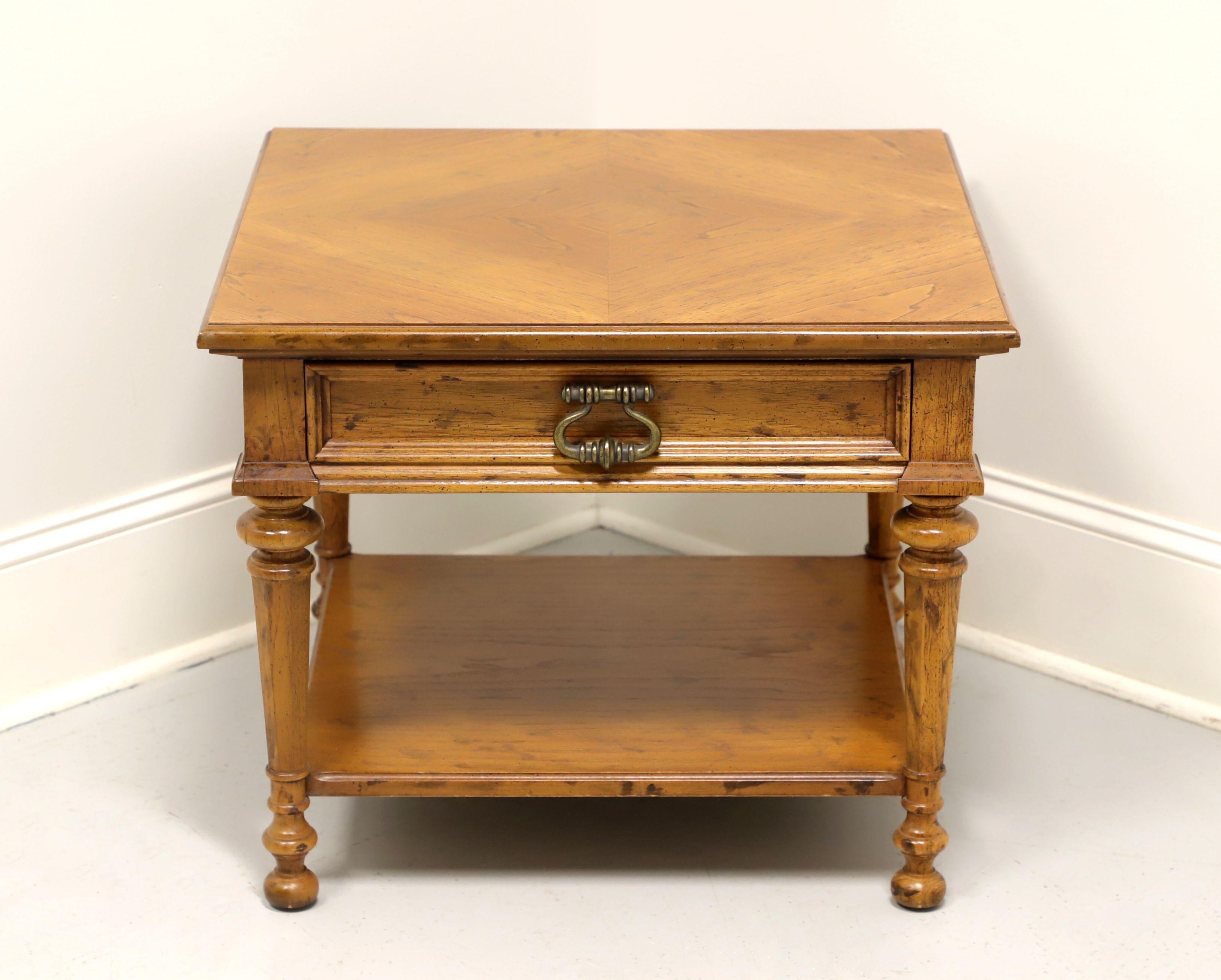 A Spanish style square end table by Drexel, from their Velero Collection. Pecan with distressed finish, parquetry top, undertier shelf and turned legs. Features one drawer of dovetail construction. Made in North Carolina, USA, circa 1969.

Style