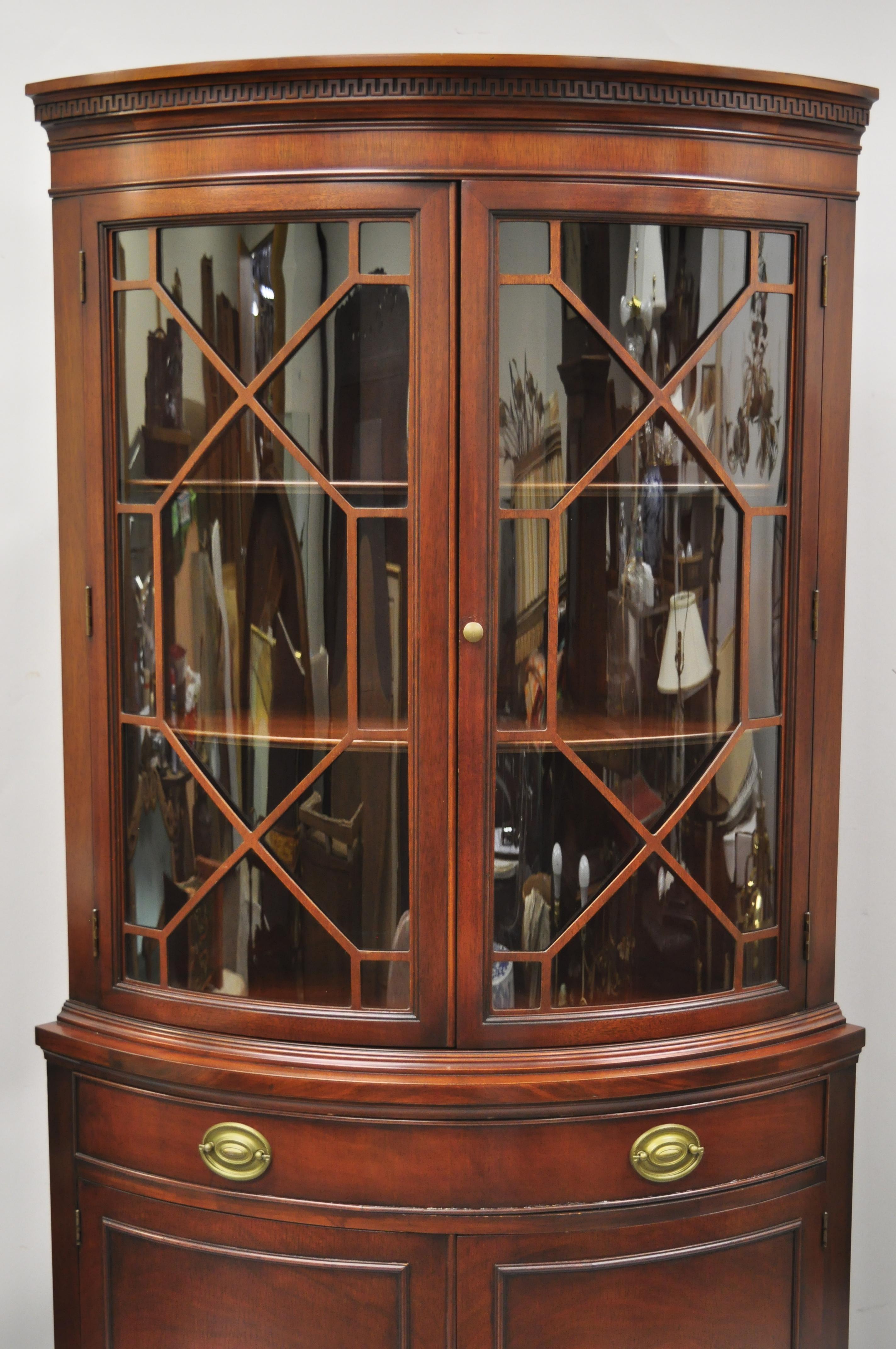 Drexel vintage mahogany bow front glass corner China cabinet Curio display. Item features lattice door panels, bow glass door fronts, beautiful wood grain, 4 swing doors, original stamp, working lock and key, 1 dovetailed drawers, solid brass