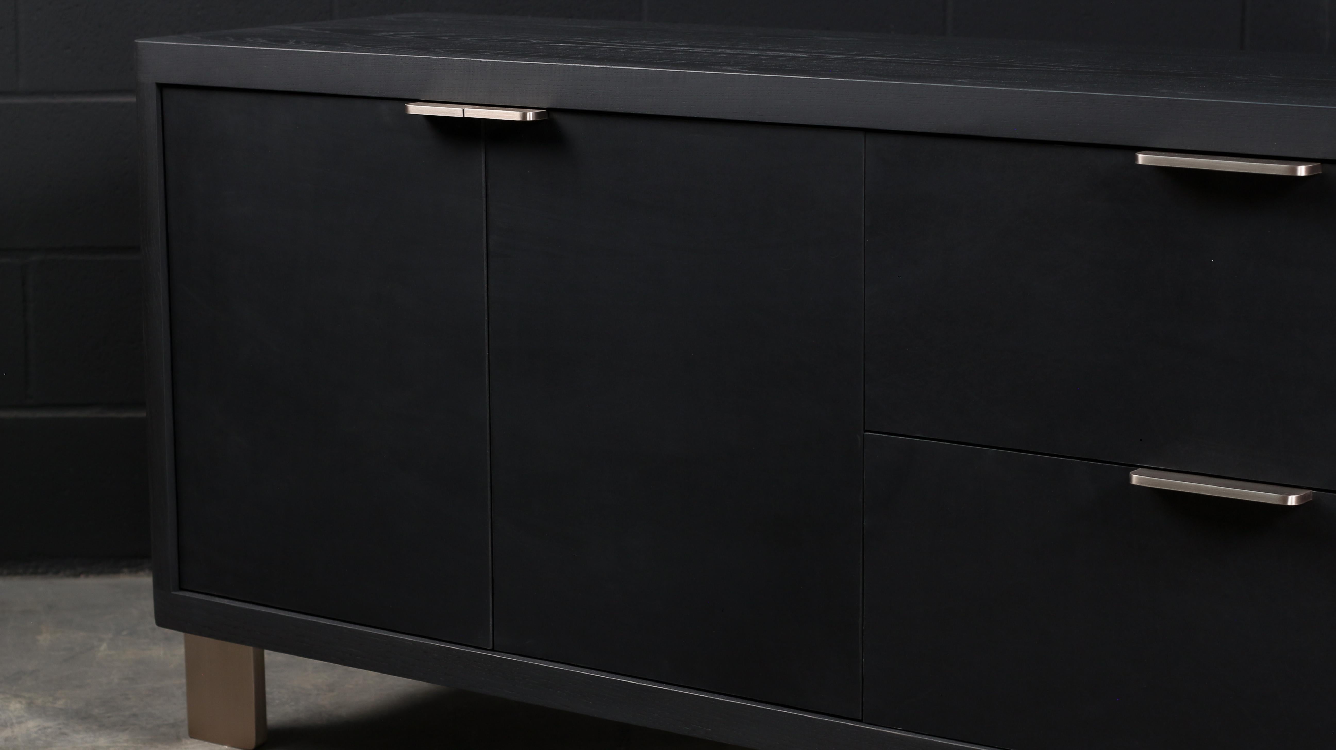 The Dreyfus Sideboard is made-to-order. Designed to store daily and occasionnals objects. The two solid wood drawers & four doors are featuring leather veneer. The Dull Champagne hardware are studio-machined and polished by hand. Wood surfaces has