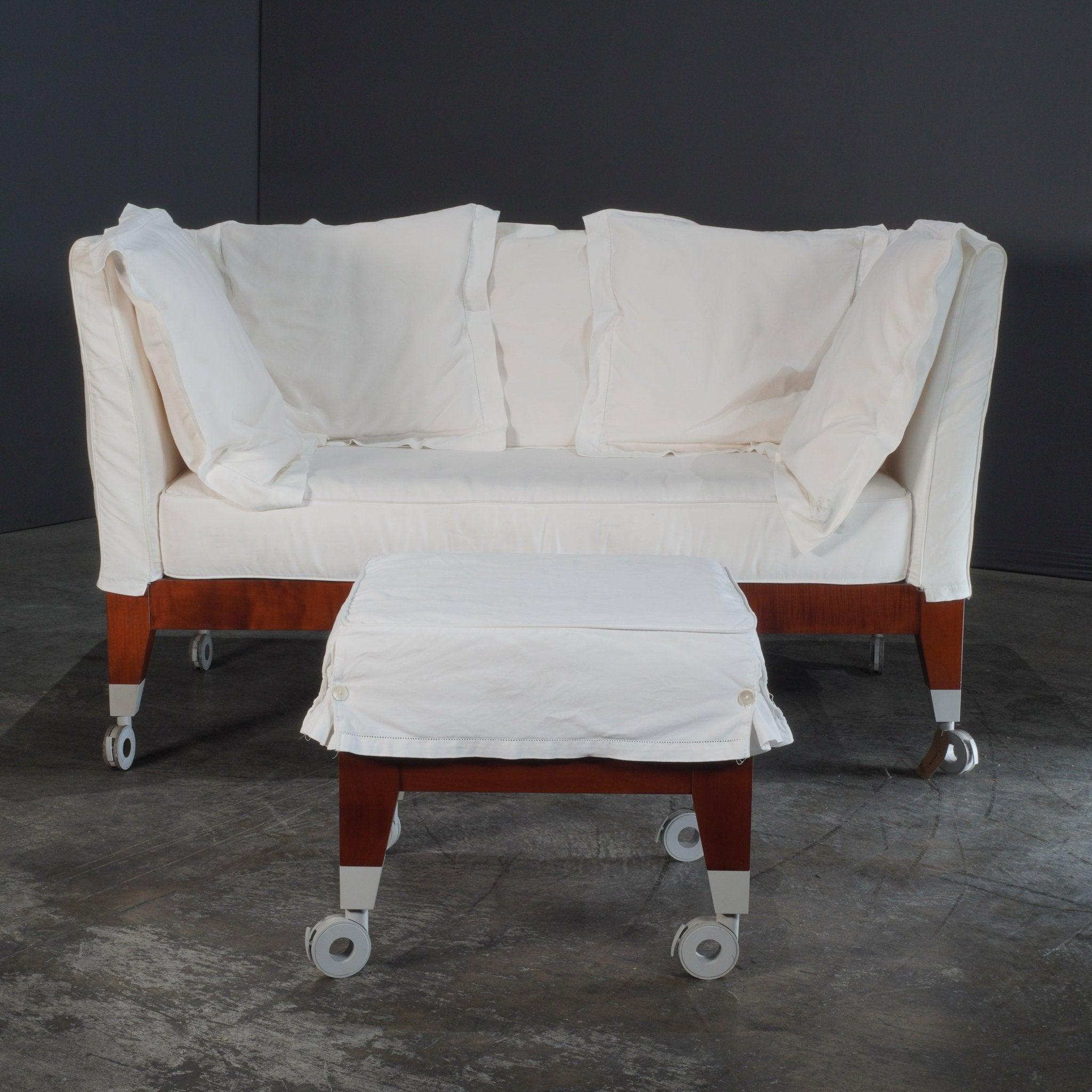 Indulge in the timeless elegance of the Driade Neoz Sofa and Pouf, crafted by the visionary designer Philippe Starck. This exquisite set exudes a luxurious charm, combining comfort with sophistication. The sofa's plush, white cushions rest