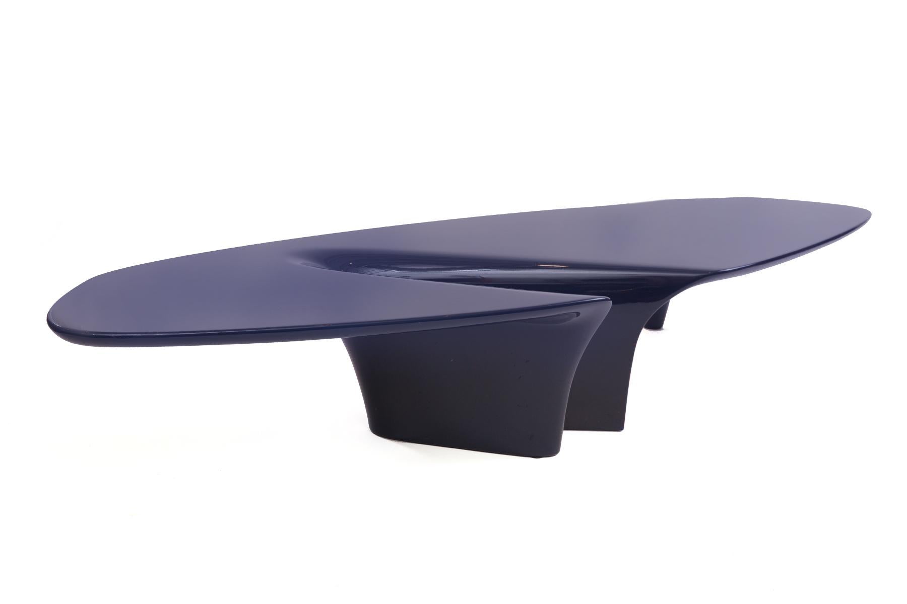 This avant-garde waterfall coffee table, designed by Fredrikson Stallard for the Italian Driade brand is made with lacquered polyurethane in a deep ocean blue. The table features an expressive waterfall-like depression in the center of the top