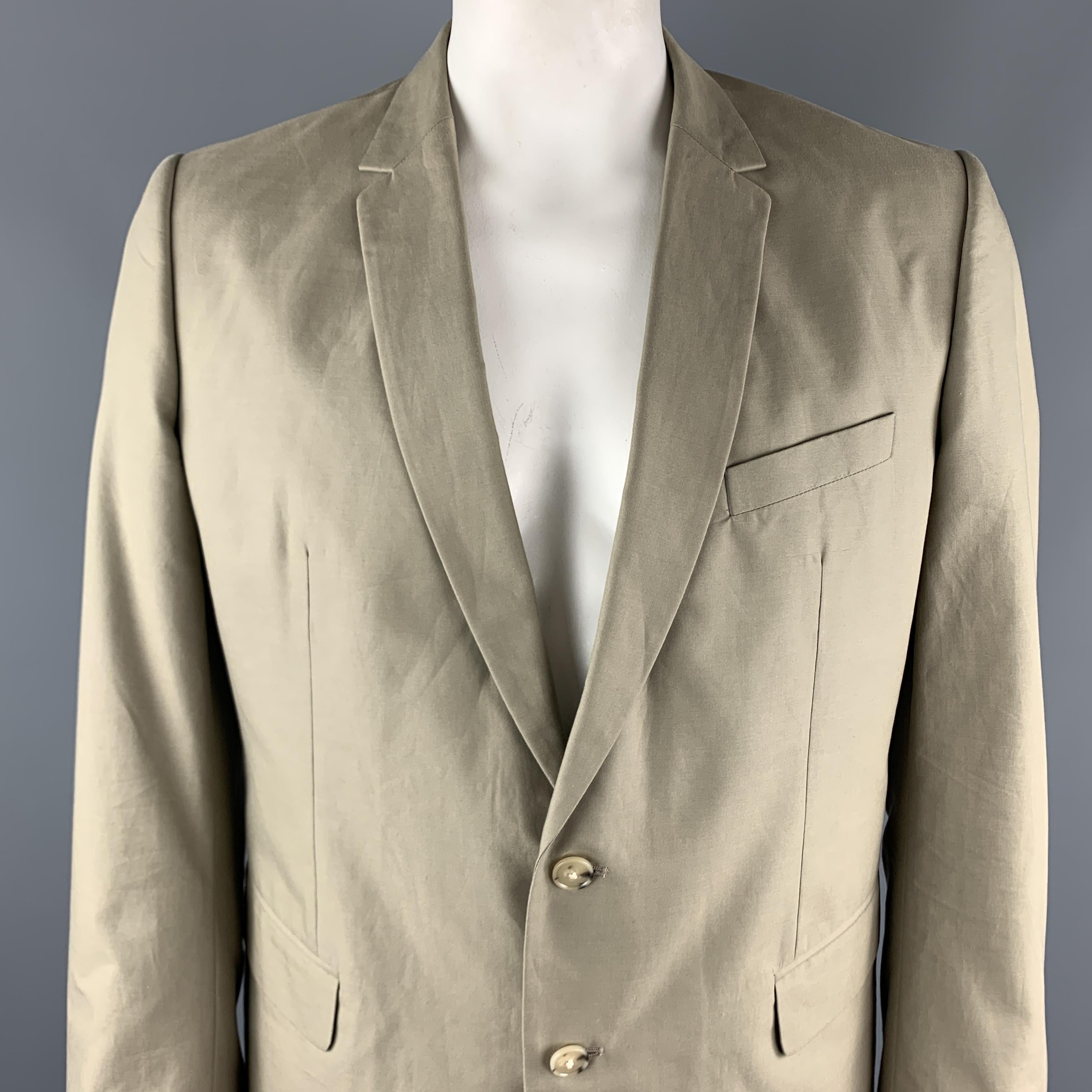 DRIES VAN NOTEN suit comes in a khaki cotton and includes a single breasted, two button sport coat with a notch lapel and matching  front trousers. 

Excellent Pre-Owned Condition.
Marked: 56

Measurements:

-Jacket
Shoulder: 16.5 in. 
Chest: 44 in.