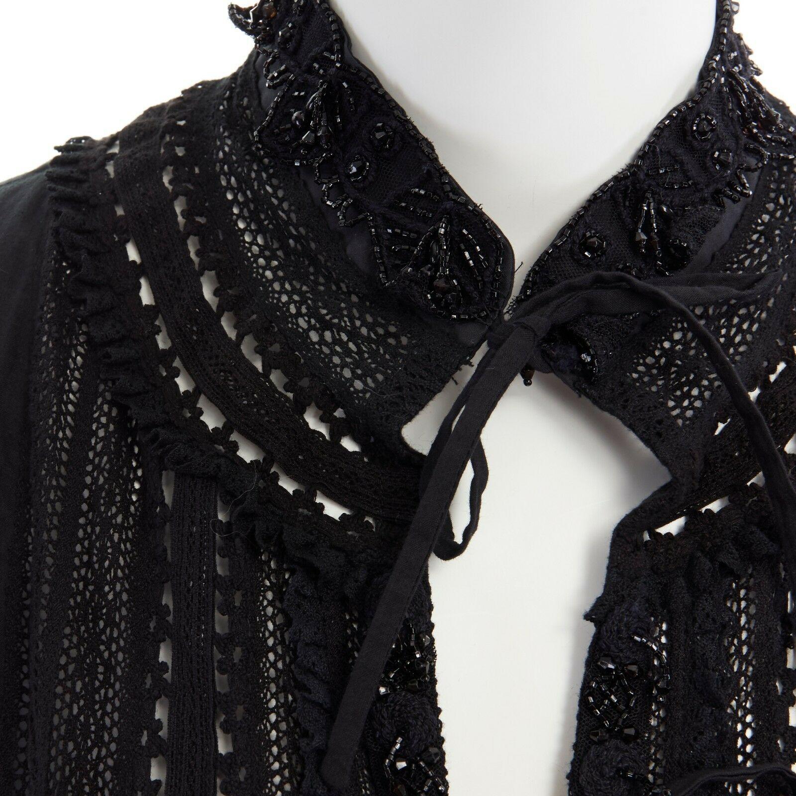 DRIES VAN NOTEN bead embellished bohemian embroidered tie front cotton top FR40

DRIES VAN NOTEN
Cotton, silk. Black. Bead embellished along collar and placket. 
Tonal floral embroidery throughout. Eyelet trim throughout. 
Rounded shoulder. Short