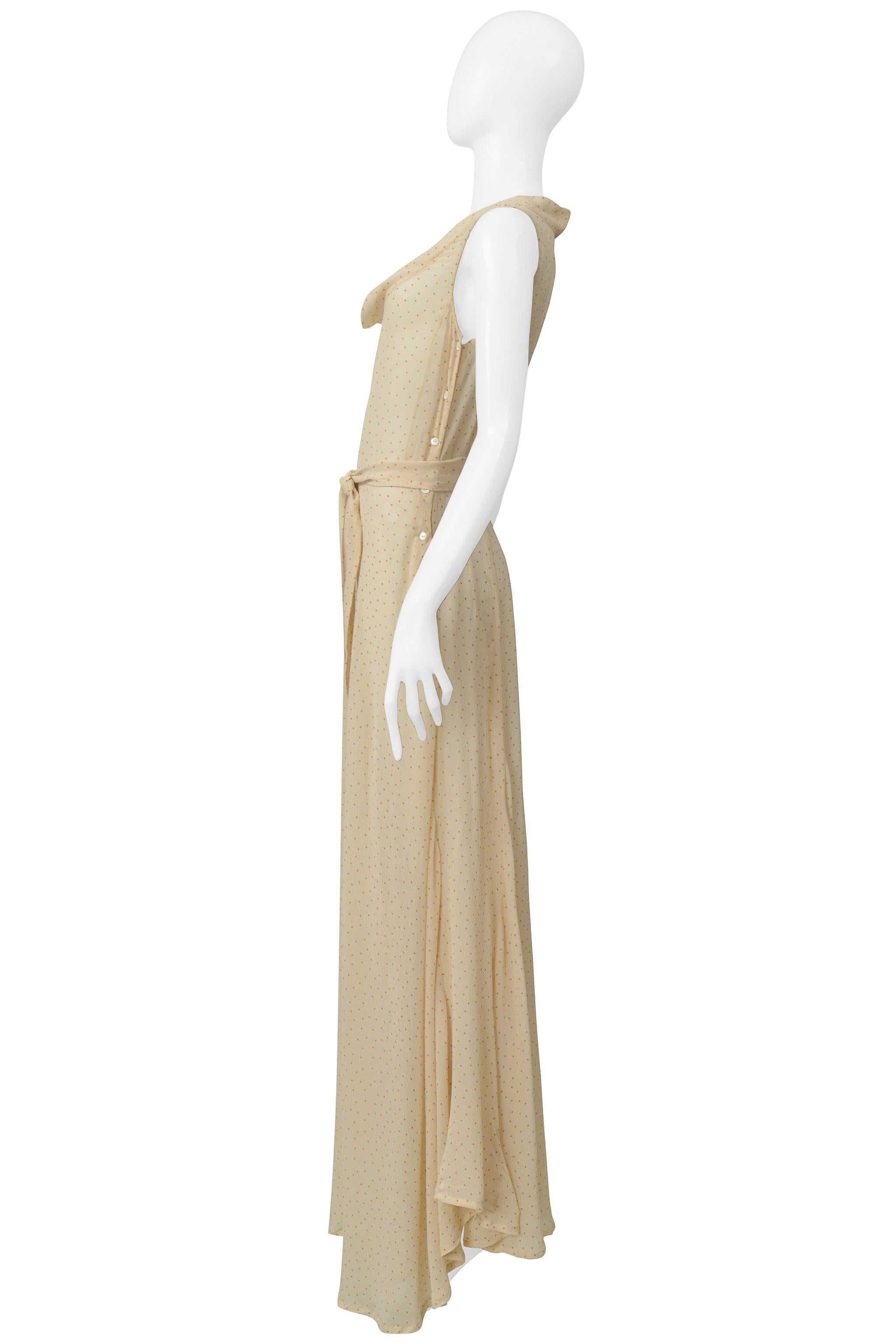 Resurrection Vintage is excited to offer a vintage Dries Van Noten creamy beige silk maxi dress featuring burnt orange mini polka dots, a cowl collar neckline, asymmetrical seaming, side buttons, droopy flounces, side slit, an uneven hem, matching