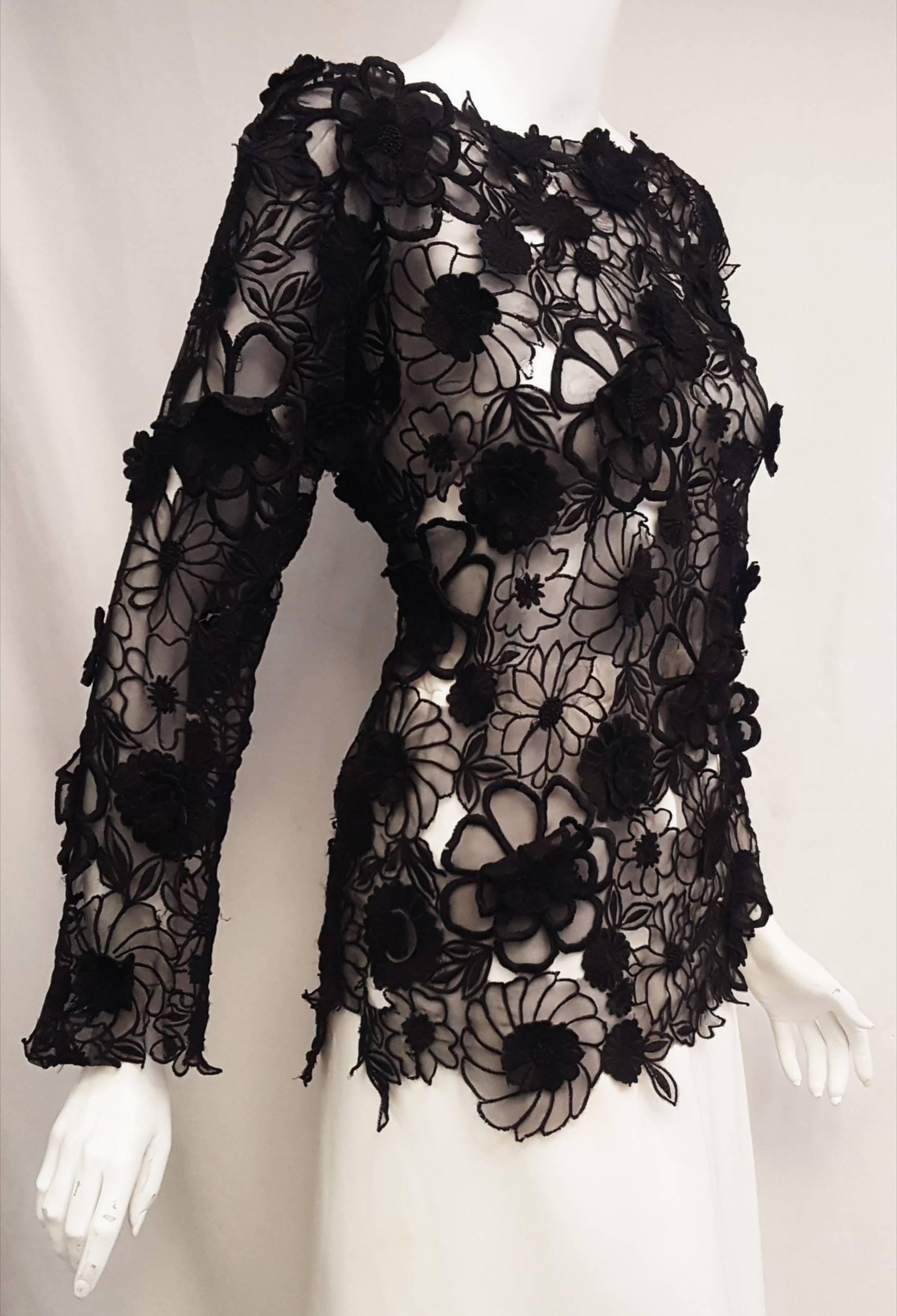 Dries Van Noten black floral applique on transparent silk fabric showcases the classic and the trendy in this feminine top that can be worn with jeans or silk palazzo slacks. With a bateau neckline and scalloped edges on the hem and long sleeves