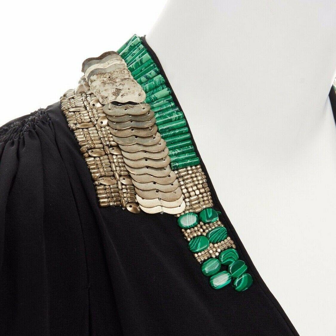 DRIES VAN NOTEN black oriental beaded embroidered silk dress FR36 US4 UK8 IT40 S

DRIES VAN NOTEN
100% SILK . ANTIQUE LOOK BRASS HEADS, SEQUINS, EMBELLISHMENT WITH ANGULAR PURPLE STONES AND JADE-LIKE GREEN BEADS EMBROIDERED ALONG NECKLINE . 
SCOOPED