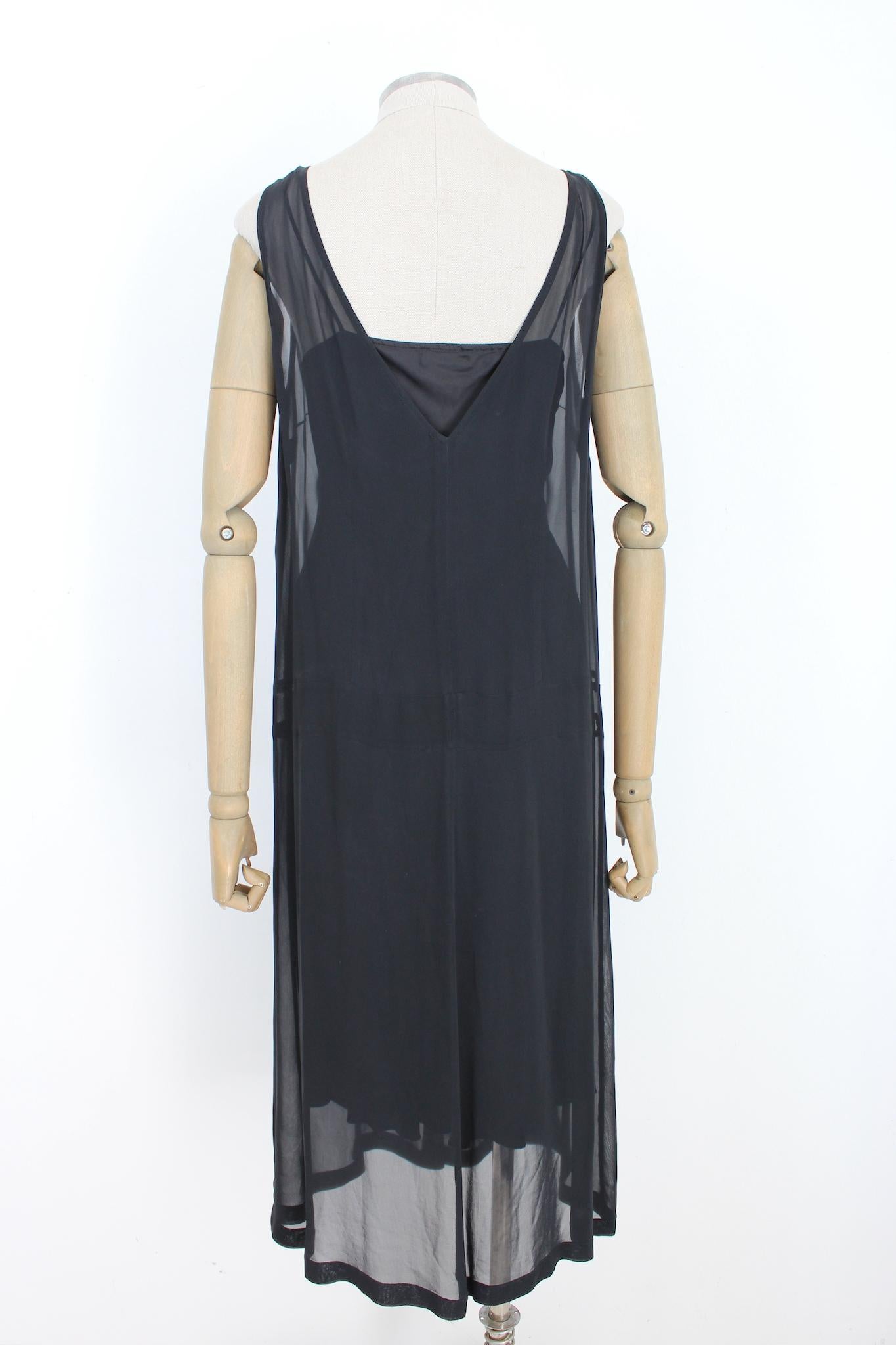 Dries Van Noten vintage 90s long evening dress. Transparent tunic dress with slip, black, sleeveless and v-neckline. Small drapery on one side. Silk fabric. Made in Belgium.

Size: 42 It 8 Us 10 Uk 38 Fr

Shoulder: 40 cm
Bust / Chest: 53 cm
Length:
