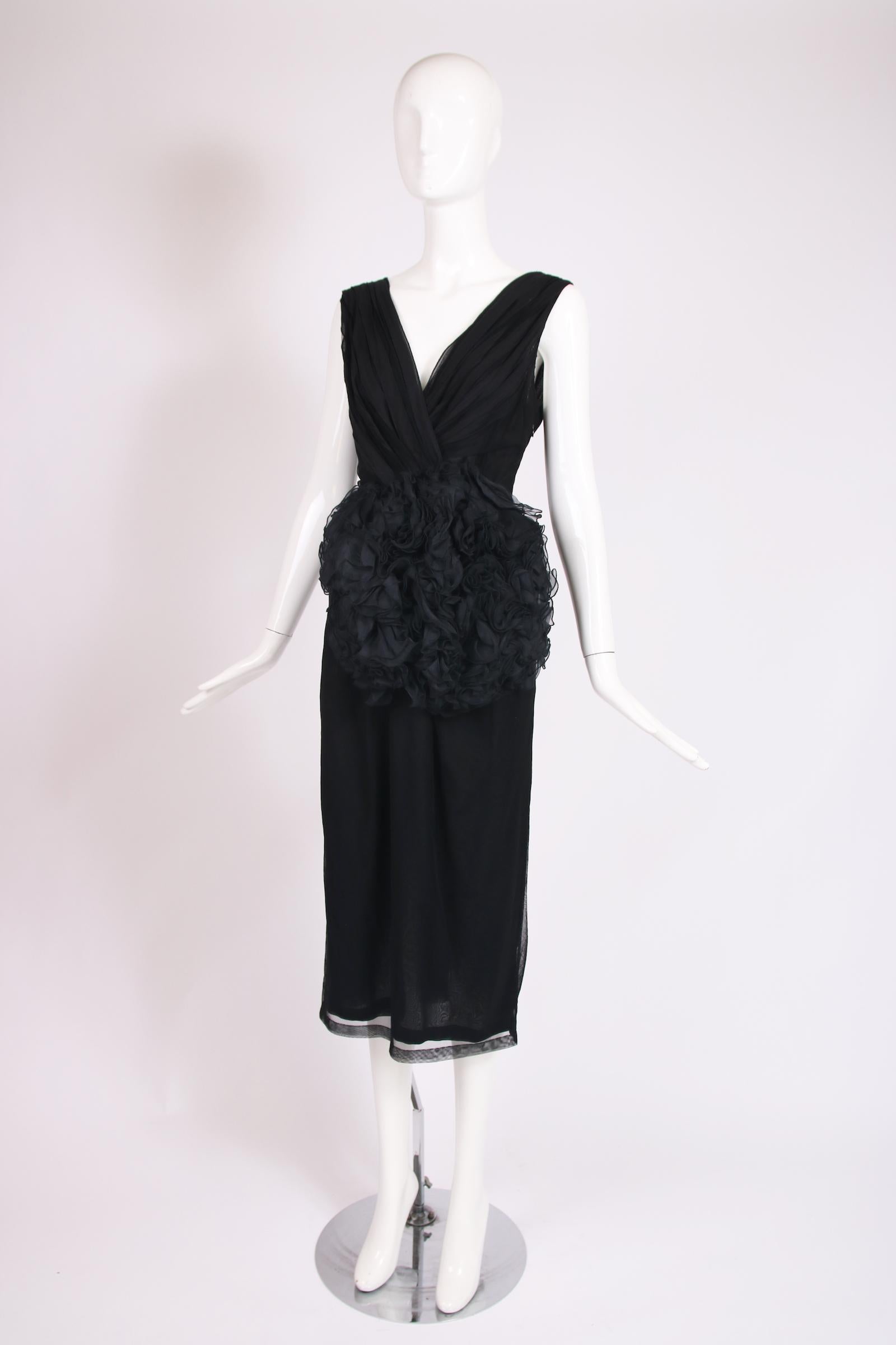Dries Van Noten black 100% silk sleeveless deep V-neck cocktail dress with oversized silk flower embellishment at the front. Size 38. In excellent condition.

Bust - 32