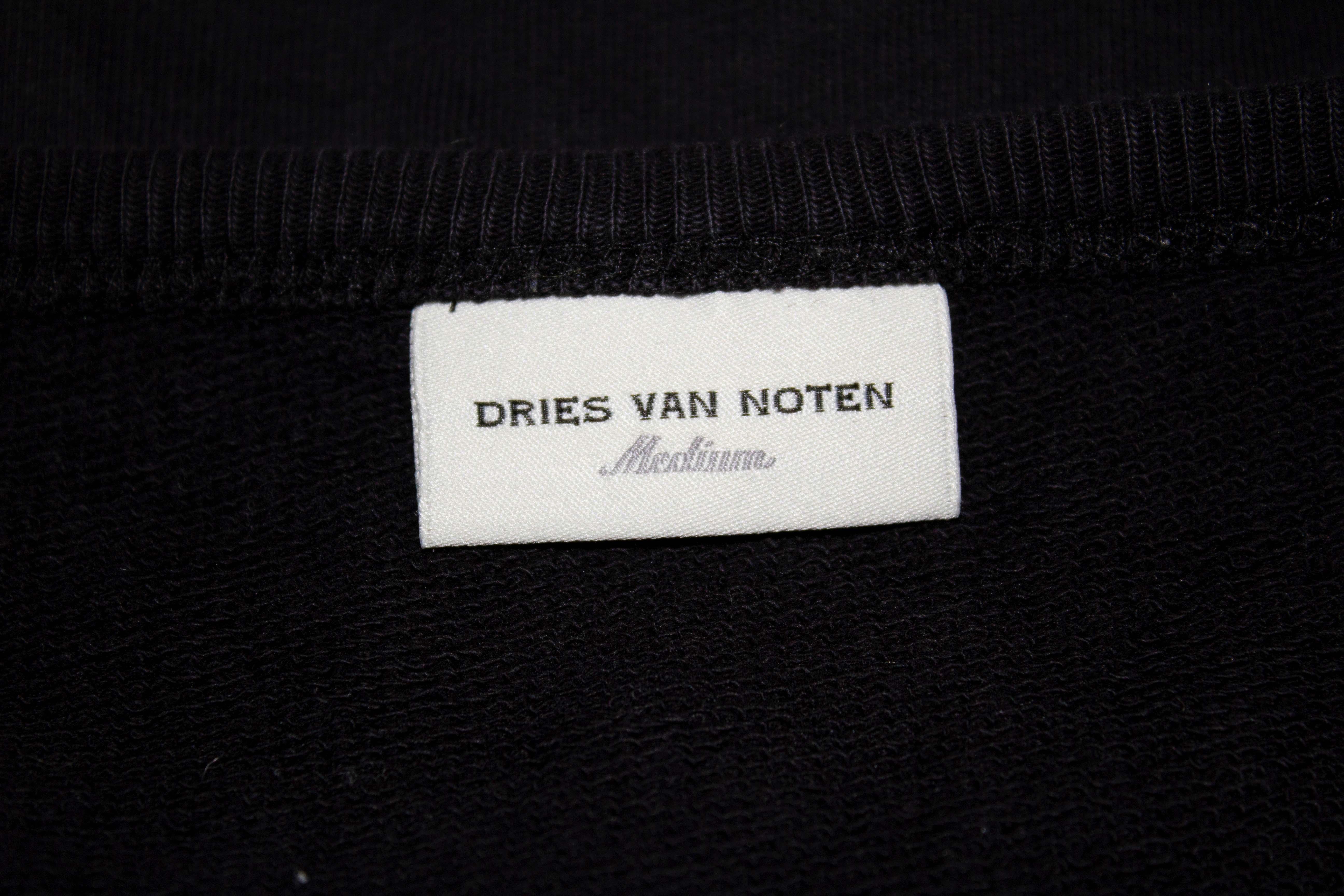 A chic and easy to wear black sweat top with white trim by  Dries van Noten. The black top has a round neckline, zip on the left hand side and white trim. 
Measurements: Bust up to 42'', length 27''.