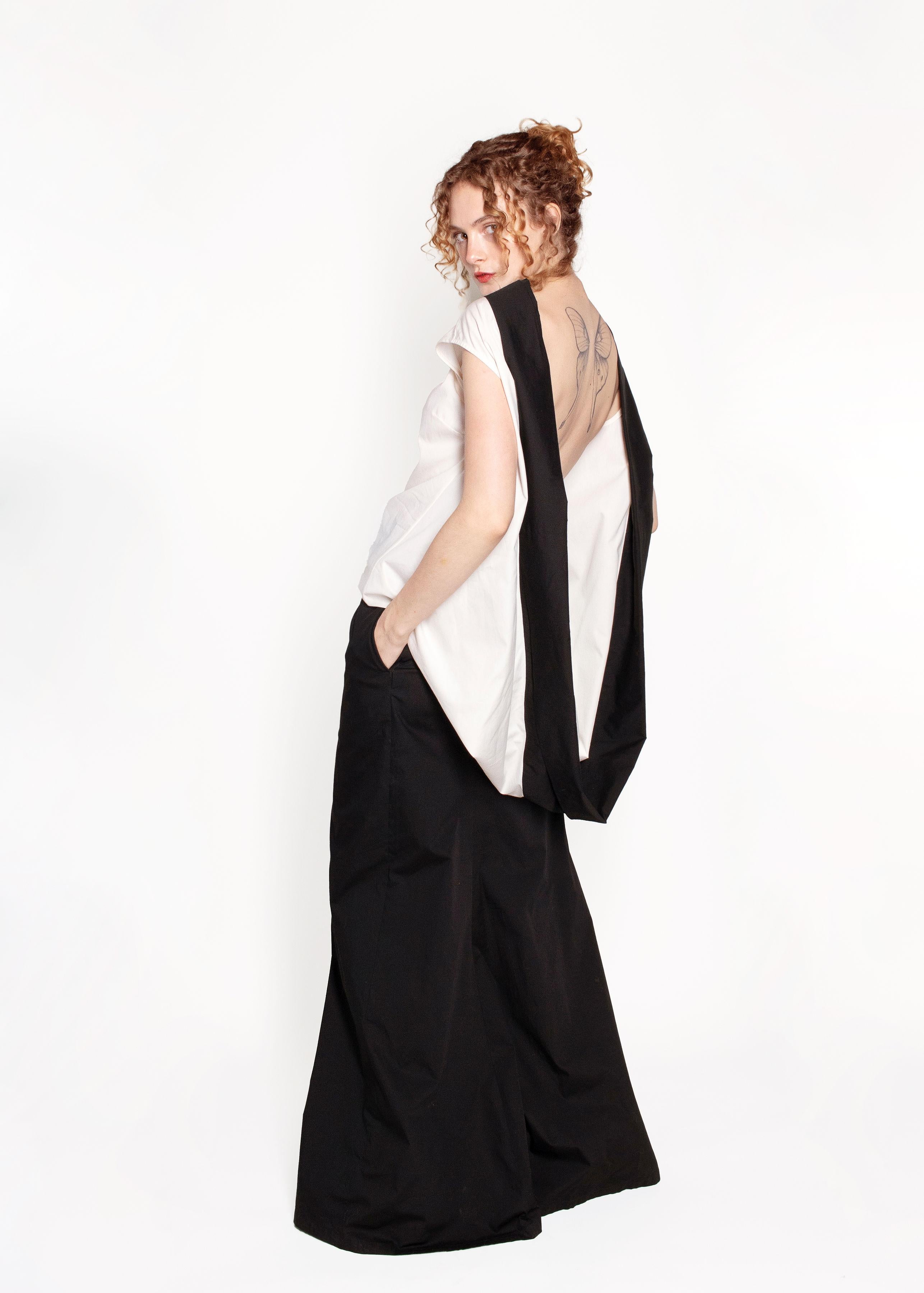 This Dries Van Noten Black/White Open Back Gown is perfect for evening occasions or special events. The open back and combination of black and white colors provide an eye-catching look that will make you stand out. The sleek and elegant design