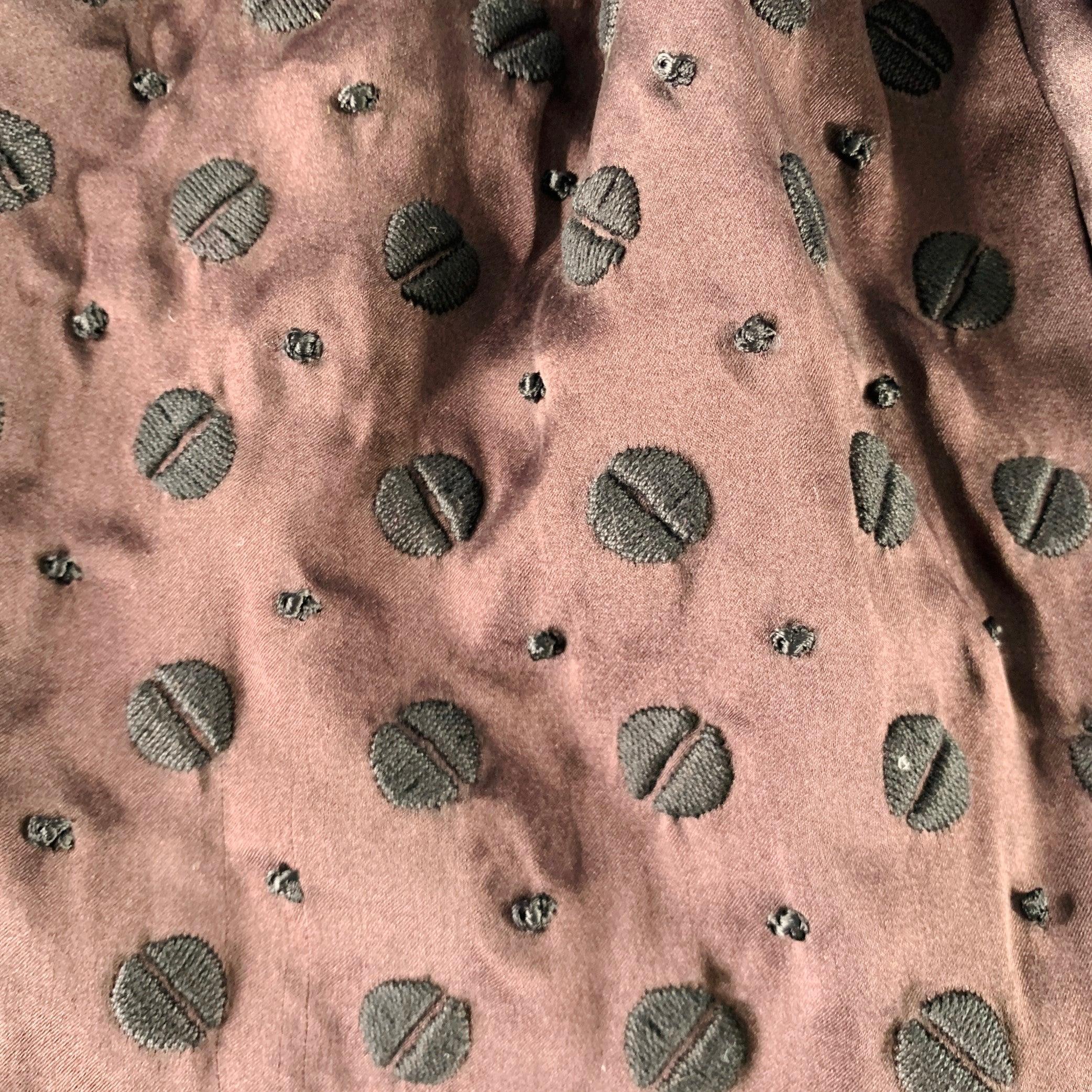 DRIES VAN NOTEN scarf in a brown silk featuring a black textured embroidered abstract pattern, and fringe details.Very Good Pre-Owned Condition.
Moderate signs of wear on fringe. 

Measurements: 
  54 inches  x 10 inches 

  
  
 
Sui Generis