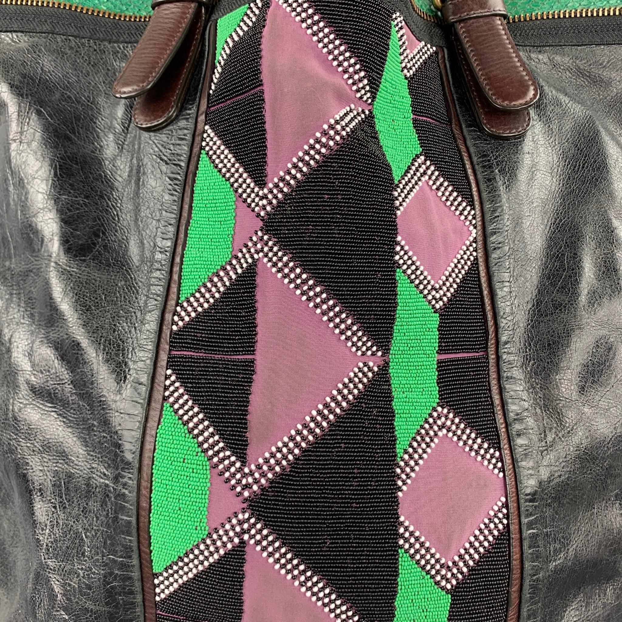 DRIES VAN NOTEN bag comes in a black leather with a green trim featuring a front beaded design, top handles, shoulder strap, double pockets, and a zipper closure.

Very Good Pre-Owned Condition.

Measurements:

Length: 14.5 in.
Width: 5.5