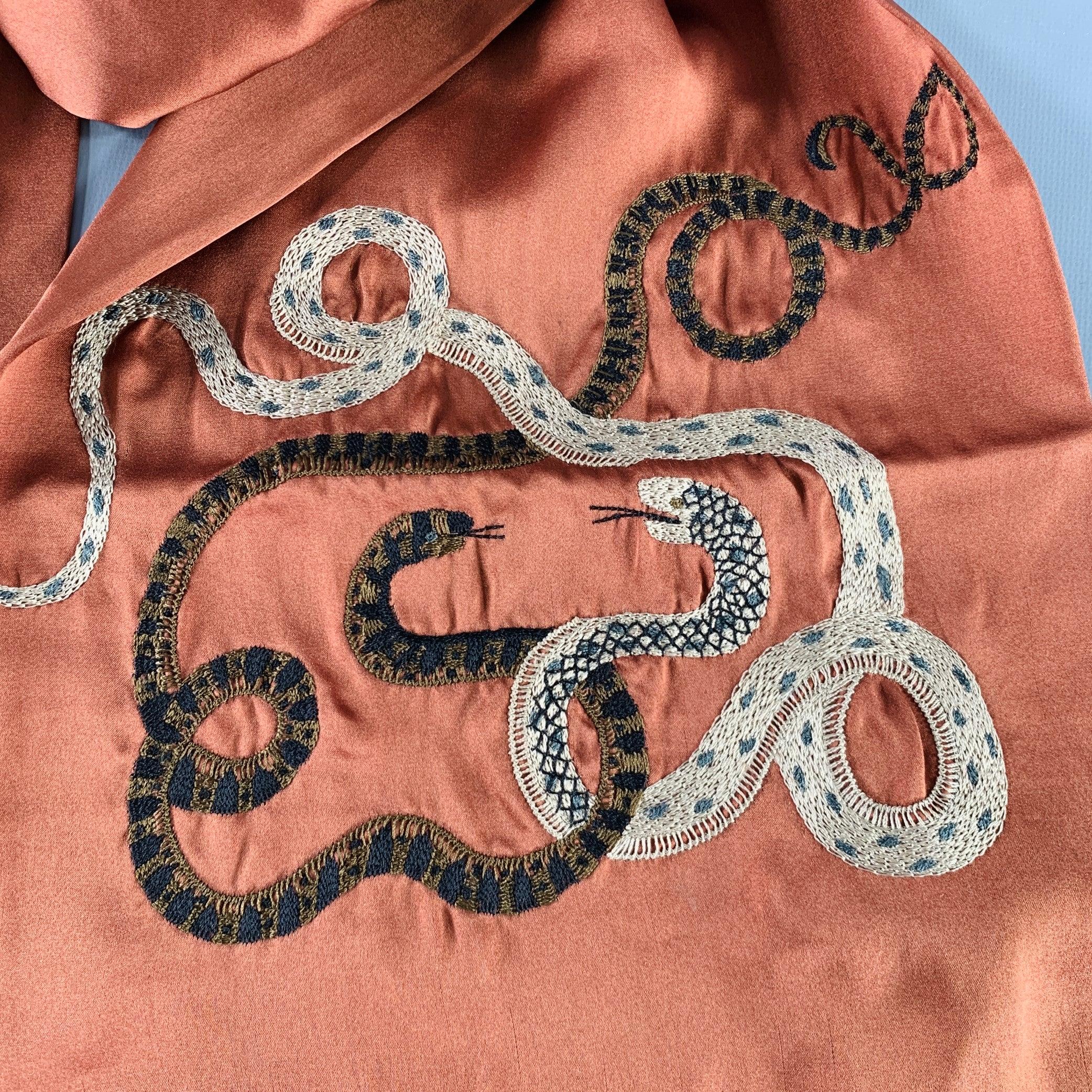 DRIES VAN NOTEN scarf in a brown satin silk featuring a grey embroidered snakes design, and fringe details.Very Good Pre-Owned Condition.
Minor signs of wear. 

Measurements: 
  52 inches  x 9.5 inches 

  
  
 
Sui Generis Reference: